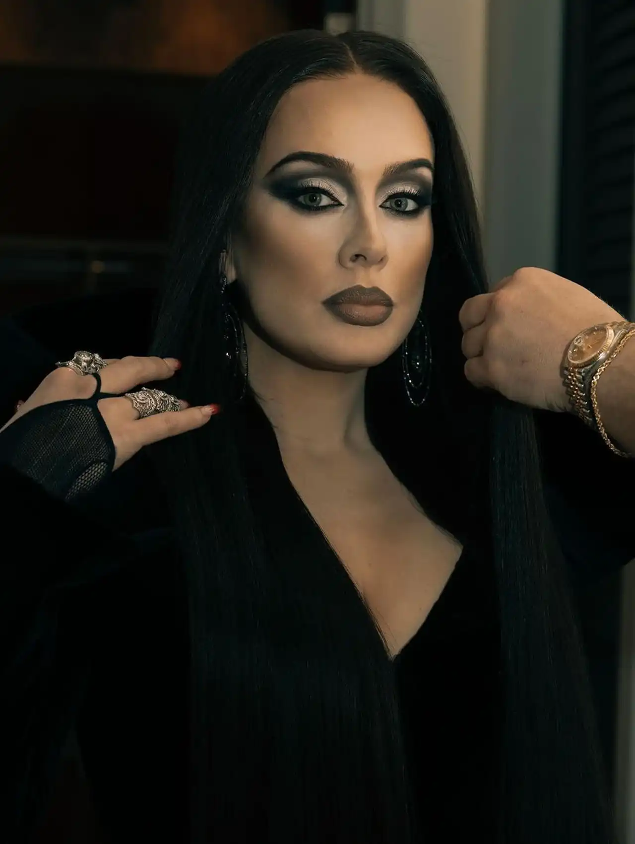 Adele dressed as Morticia Addams in a gothic look for celebrity Halloween costumes.