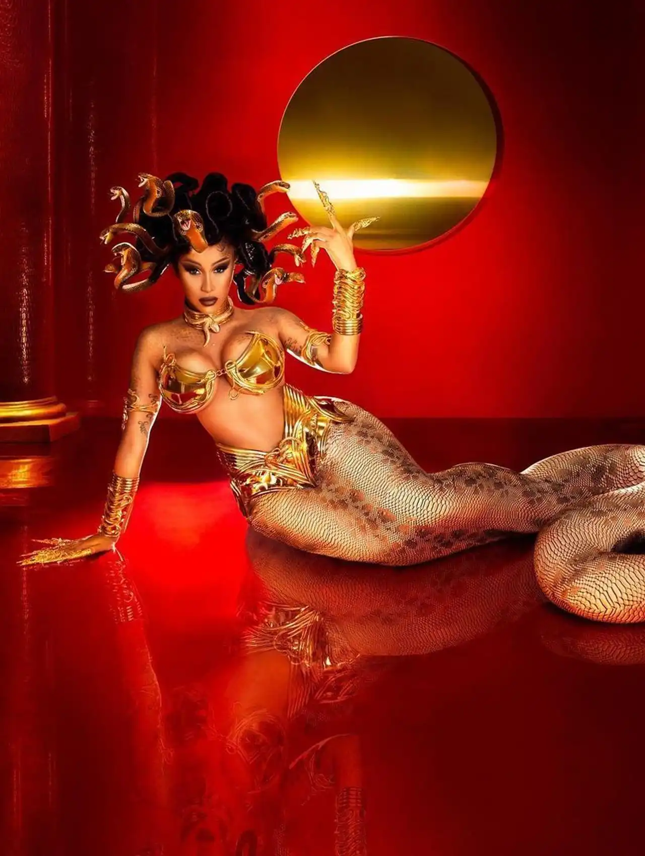 Cardi B dressed as Medusa in a golden serpentine costume for celebrity Halloween costumes.