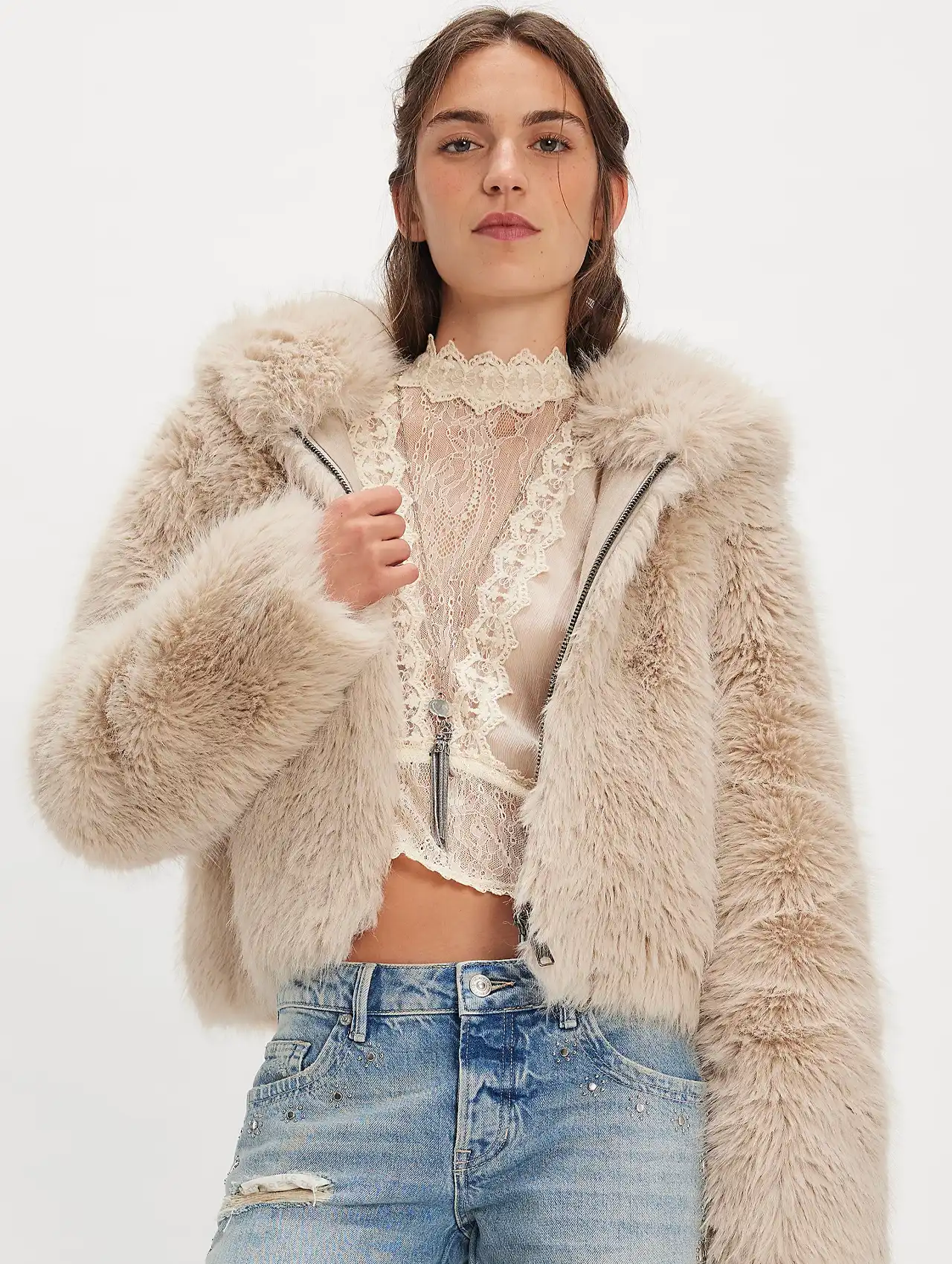 Woman in a beige faux fur jacket styled as fashionable fall jackets.
