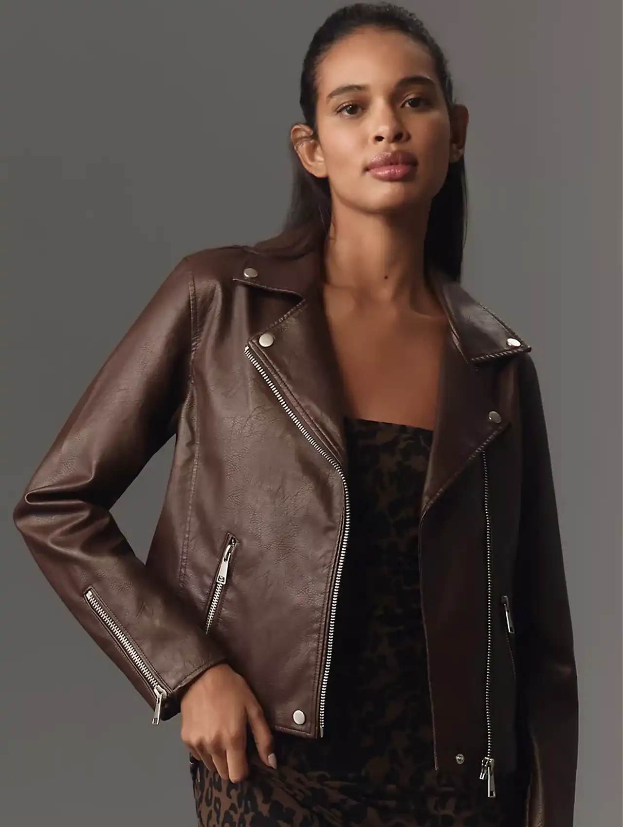 Woman in a brown moto leather jacket styled as edgy fall jackets.