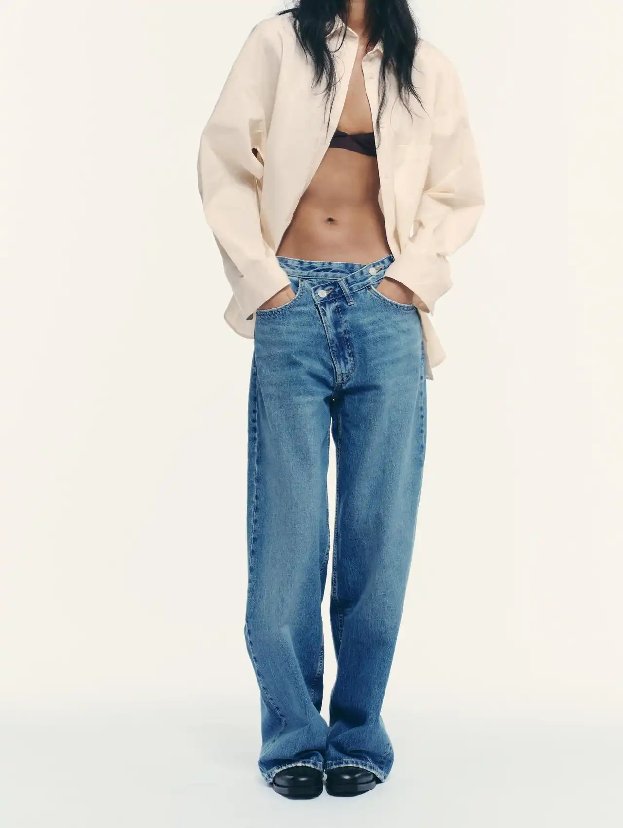 Woman in oversized shirt and relaxed denim jeans for casual fashion inspiration