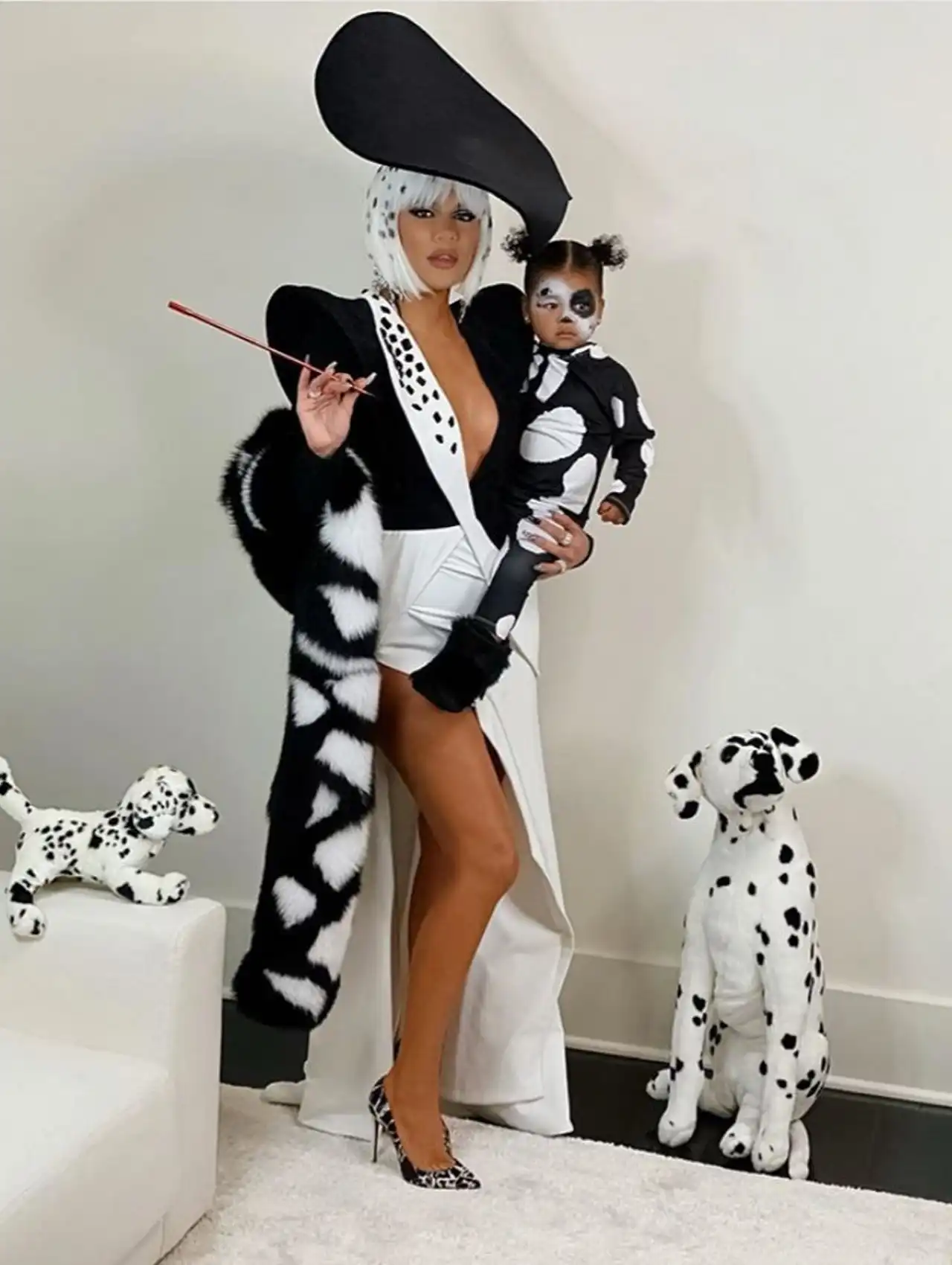 Khloé Kardashian dressed as Cruella de Vil from 101 Dalmatians for celebrity Halloween costumes.