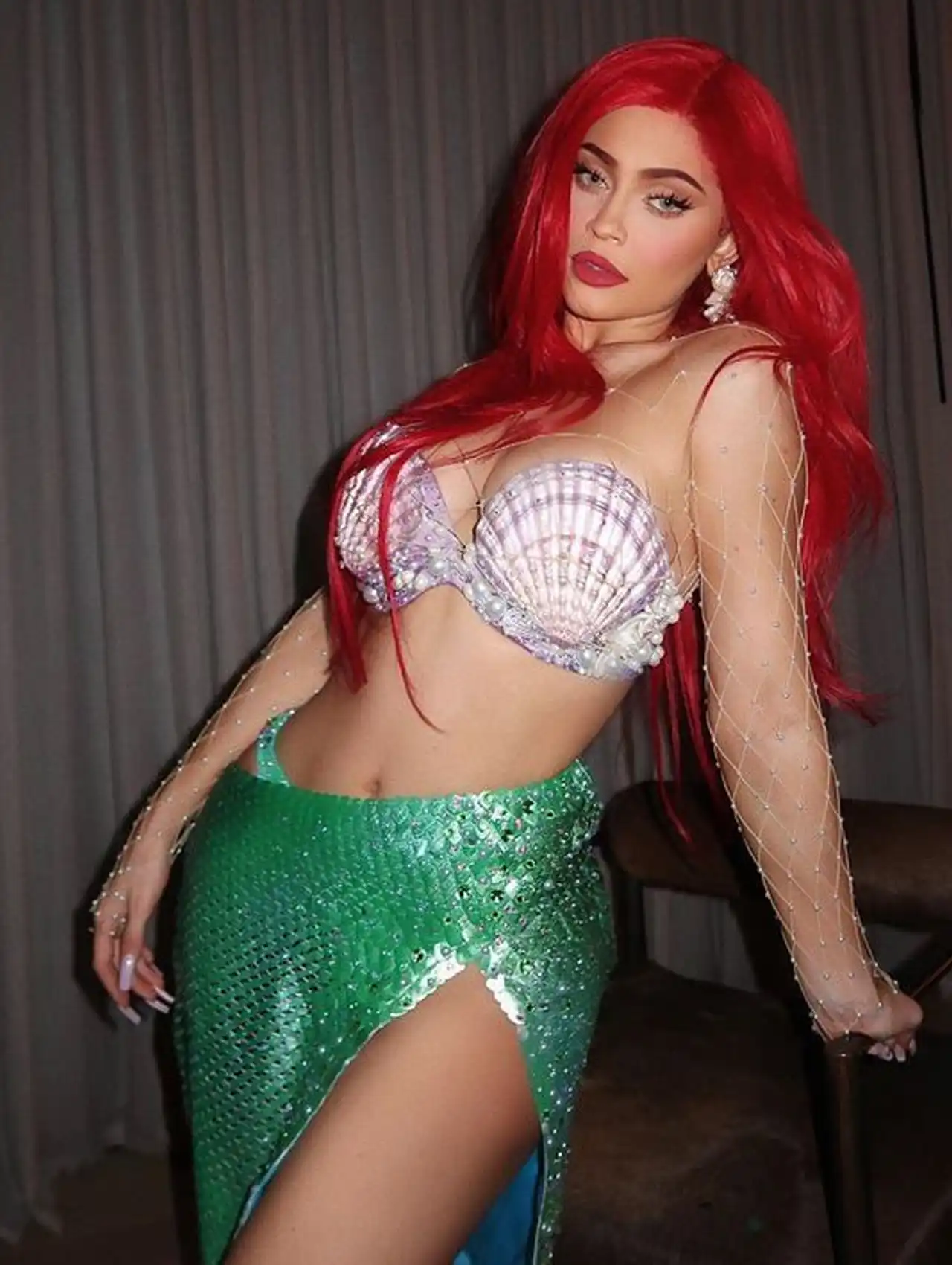  Kylie Jenner dressed as Ariel from The Little Mermaid with red hair for celebrity Halloween costumes.