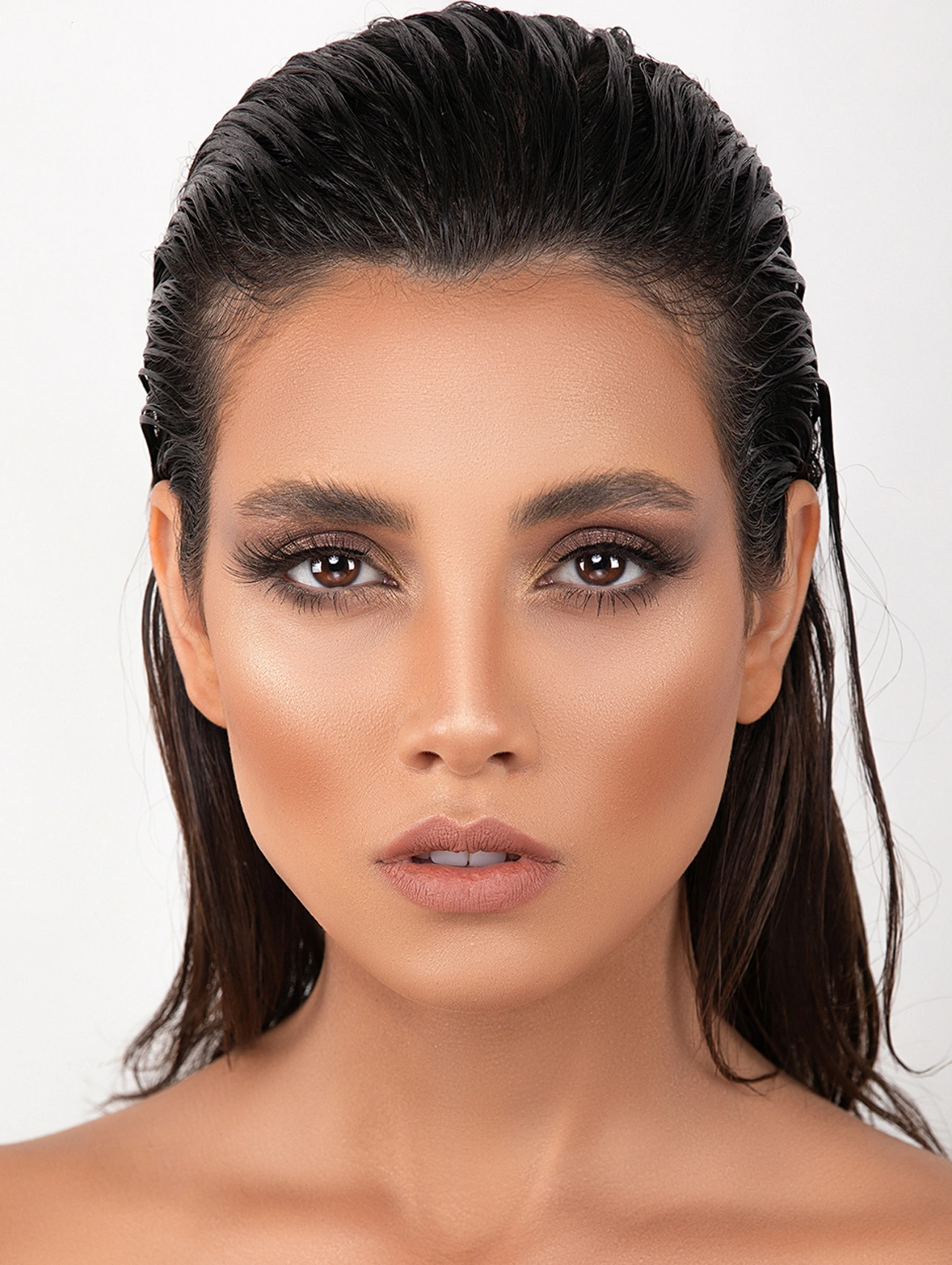 Elegant woman with sleek makeup, smoky eyes, and nude lips — stylish Thanksgiving makeup trend for 2025.