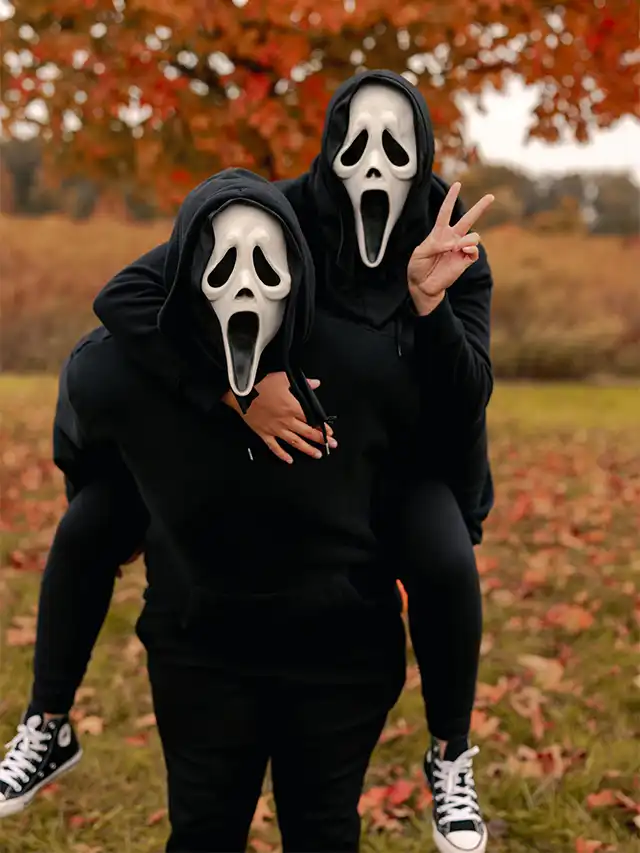 a couple of people wearing black masks