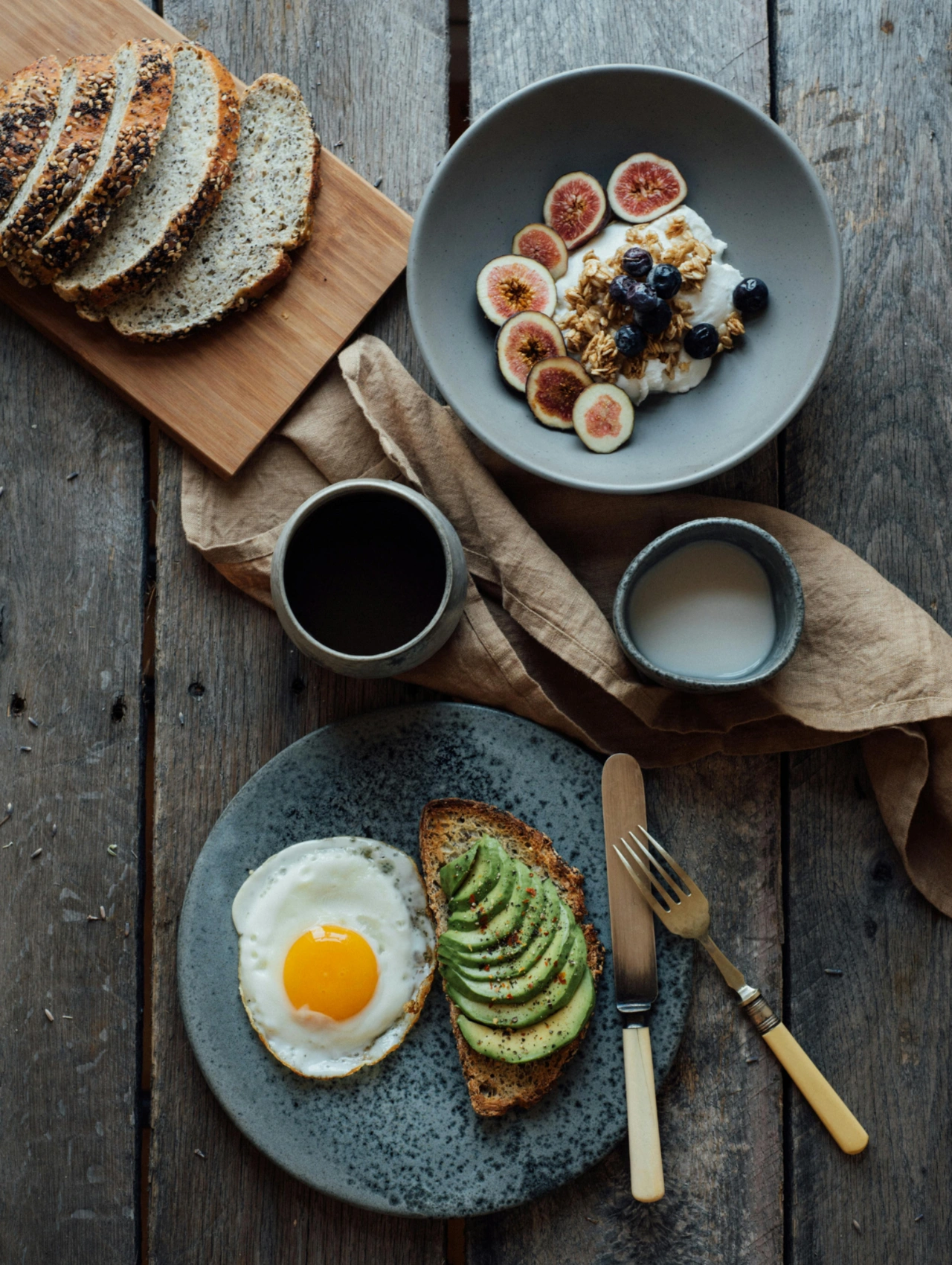 Conclusion on intermittent fasting results showing a balanced breakfast with eggs, avocado toast, yogurt, and fruit.