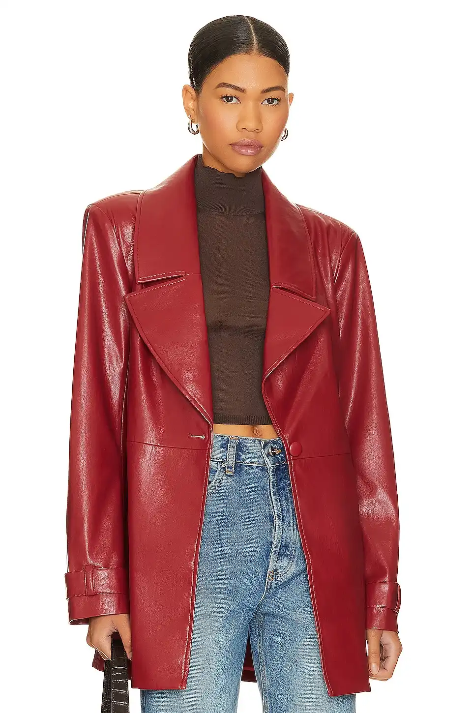 Woman wearing a red leather blazer paired with jeans and brown top