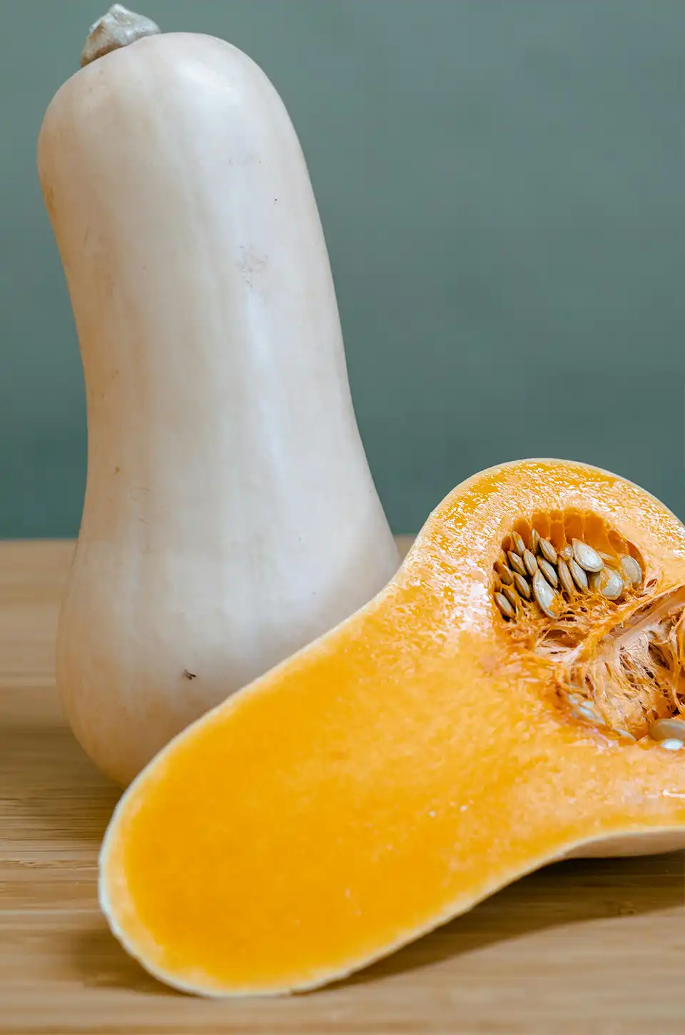 Fresh winter squash cut in half showing seeds – fall soup recipes ingredient