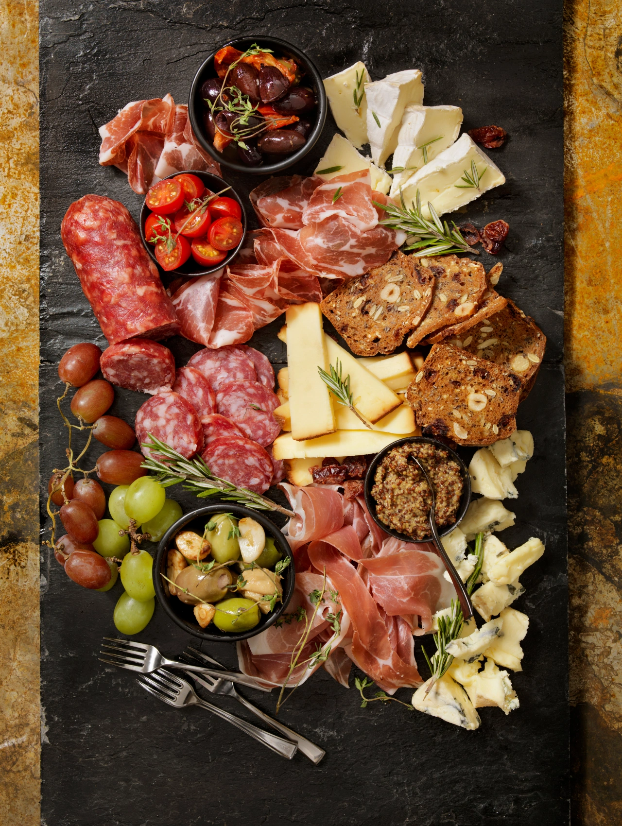 Charcuterie board with meats, cheeses, olives, and bread, perfect for christmas dinner ideas and elegant holiday entertaining