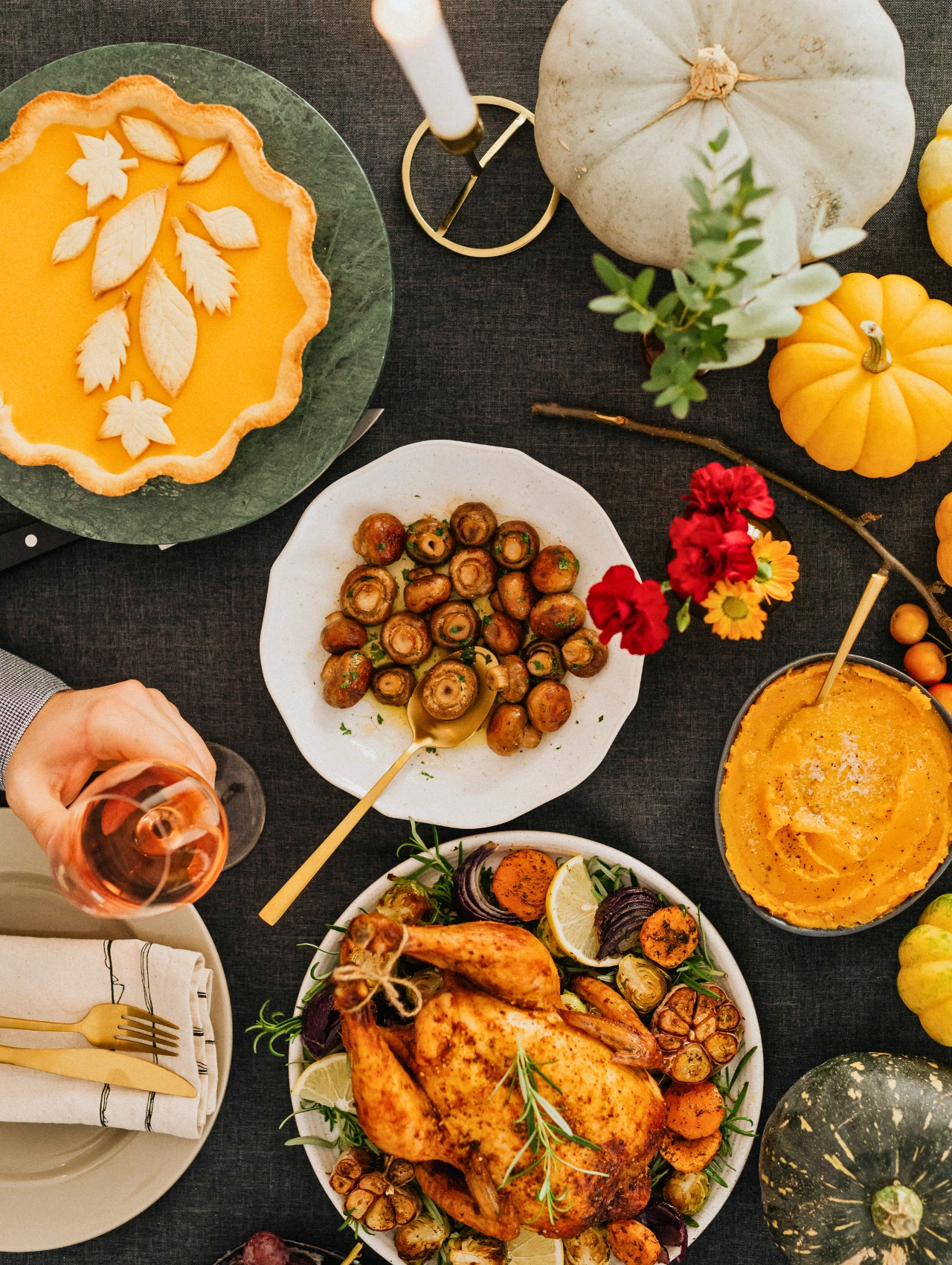 Flatlay of roasted chicken, pumpkin pie, vegetables, and holiday sides, offering warm and delicious christmas dinner ideas