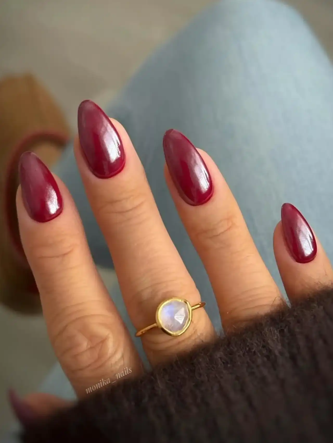 Almond-shaped nails with deep burgundy polish, nail art design 2025.