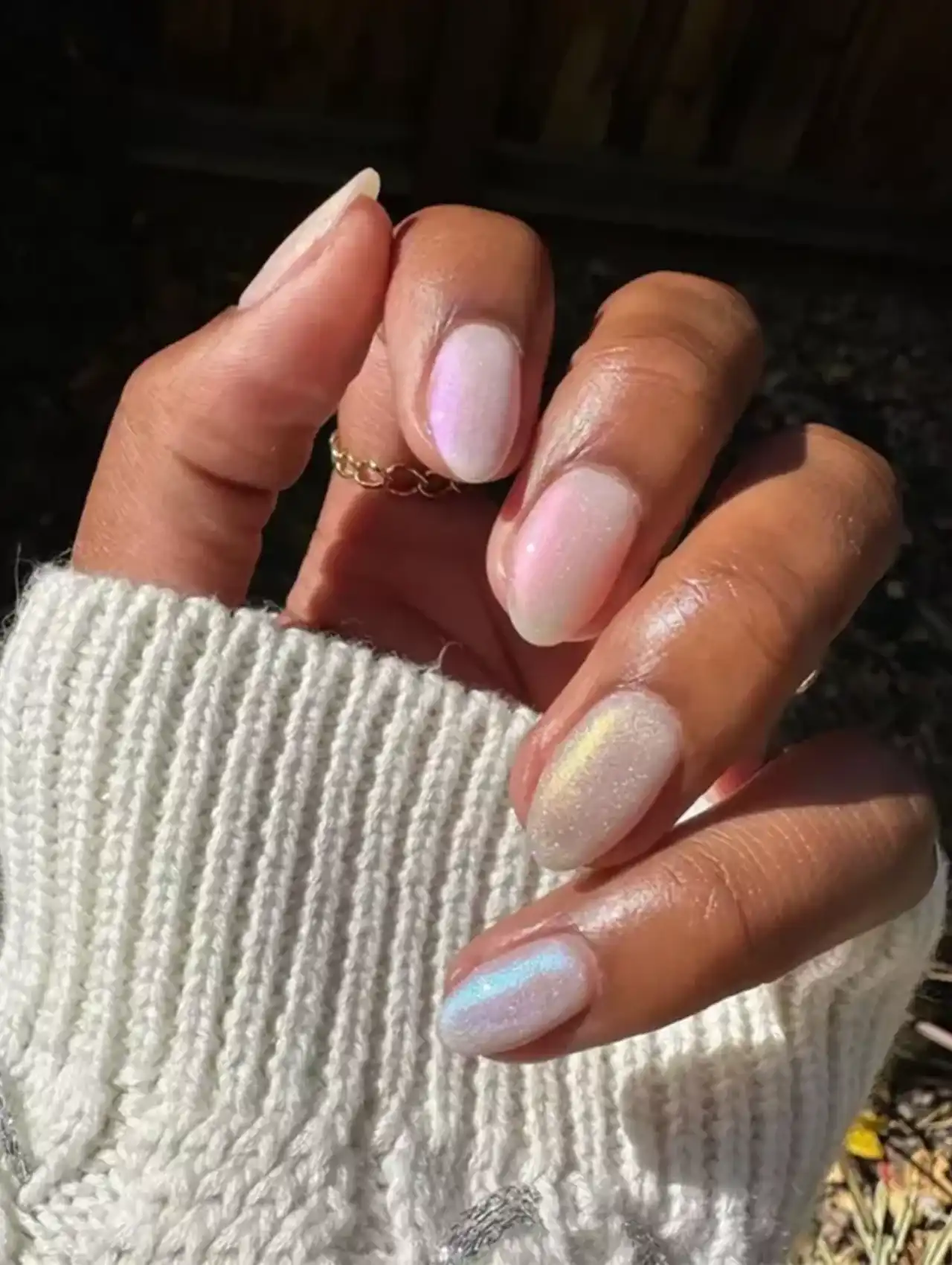 Oval nails with iridescent shimmer finish, showcasing nail art design 2025.