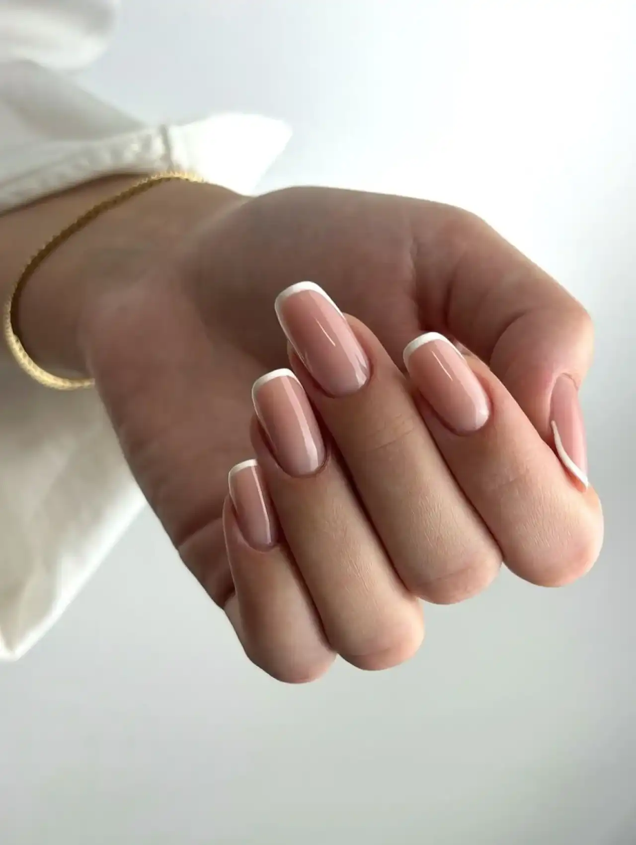 Short nails with micro French white tips, showcasing nail art design 2025.