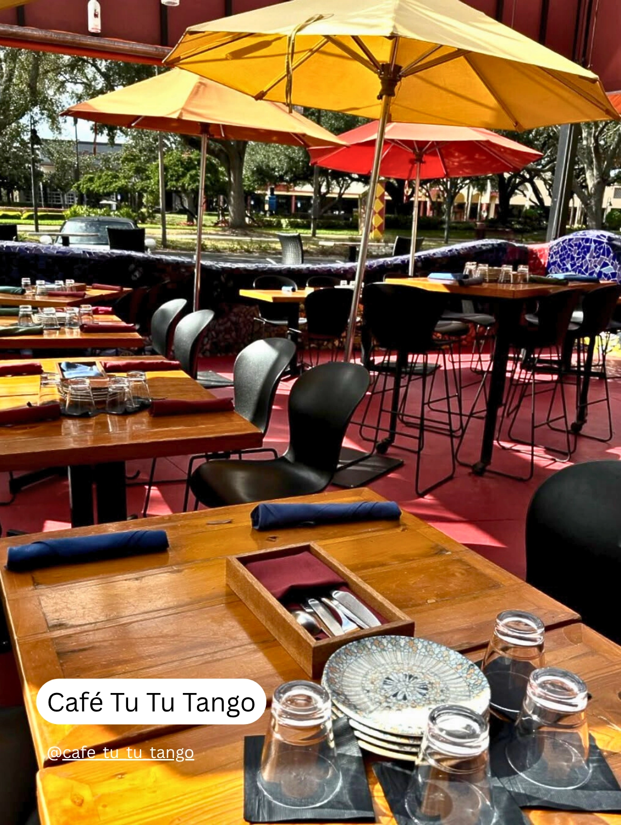 Outdoor dining area with colorful umbrellas at Café Tu Tu Tango, one of the top pet friendly restaurants in Orlando.