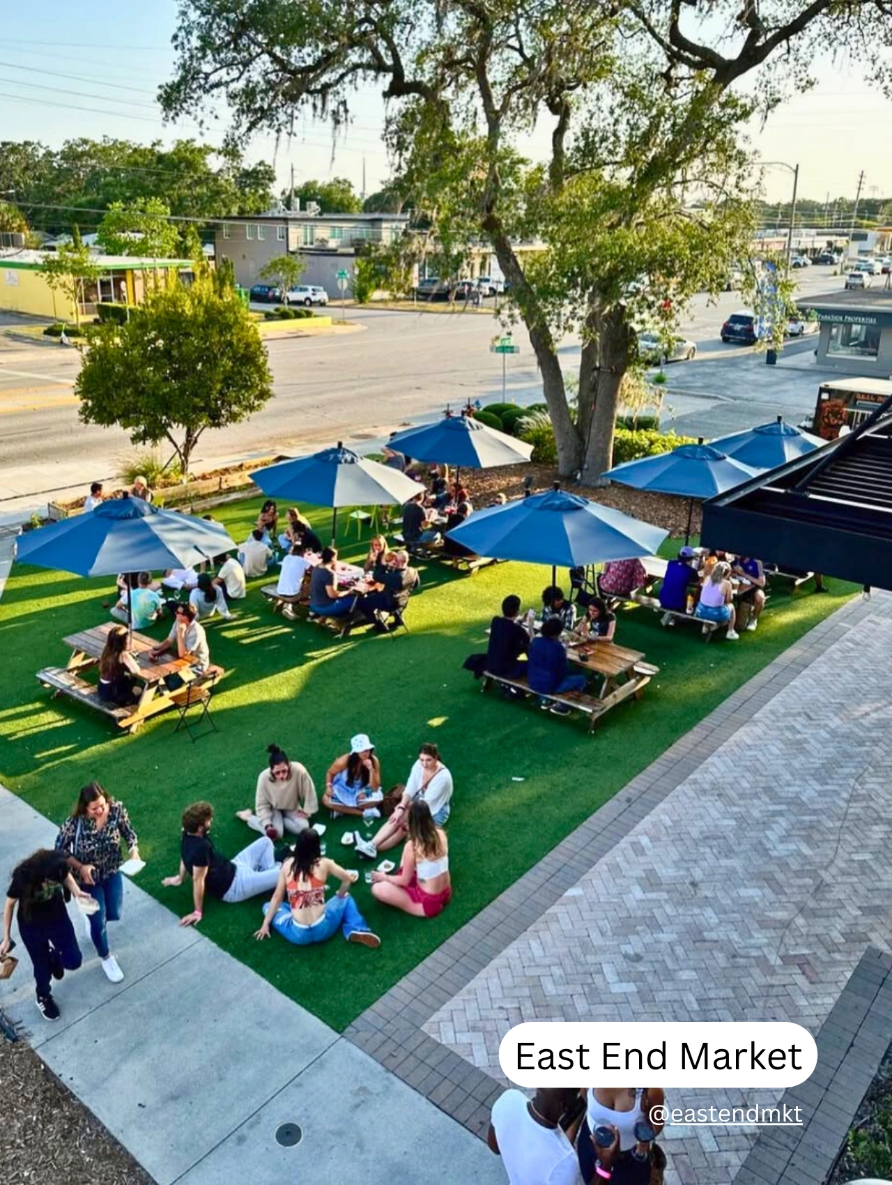 Crowds relaxing on the lawn at East End Market, a top pet friendly restaurant hub in Orlando.