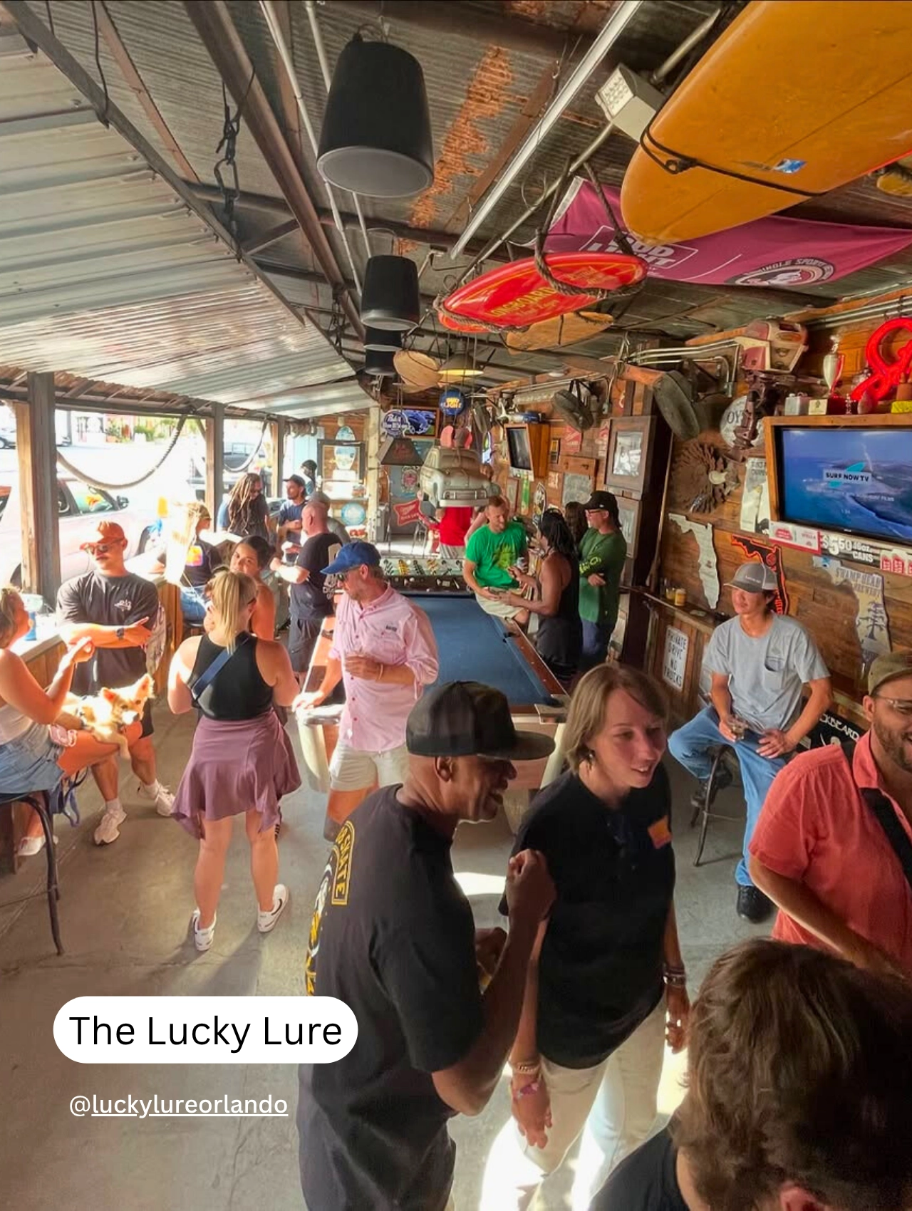 Busy crowd enjoying drinks and socializing at The Lucky Lure, a popular pet friendly restaurant and bar in Orlando.
