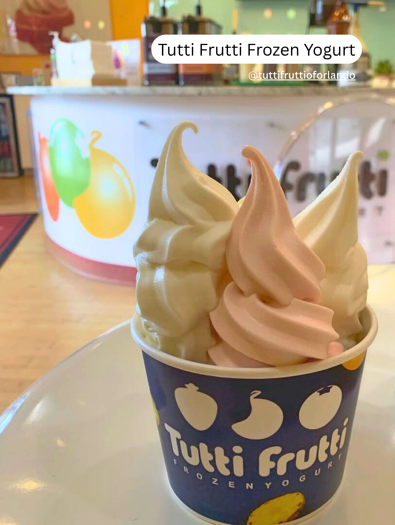 Close-up of colorful frozen yogurt in a cup at Tutti Frutti Frozen Yogurt shop.