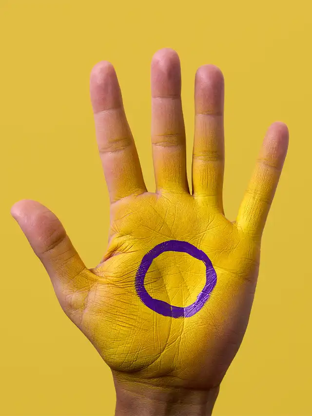 a hand with a purple circle painted on it
