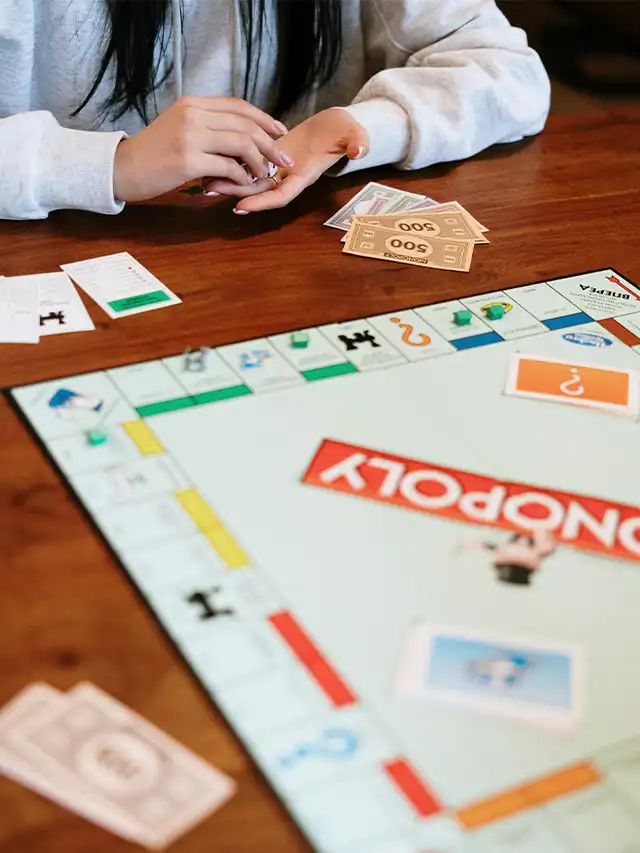 a person holding their hands over a board game