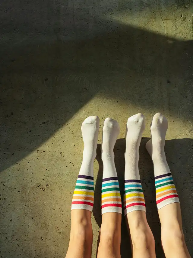 a group of people's legs with white socks