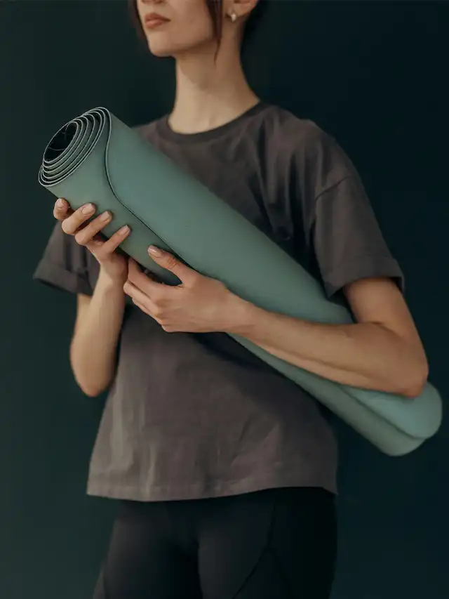 a person holding a yoga mat