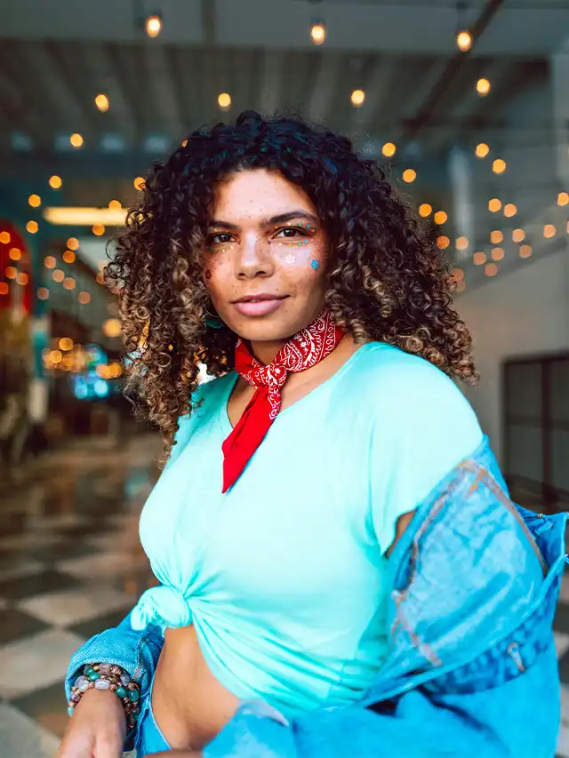 a woman with curly hair and a blue shirt