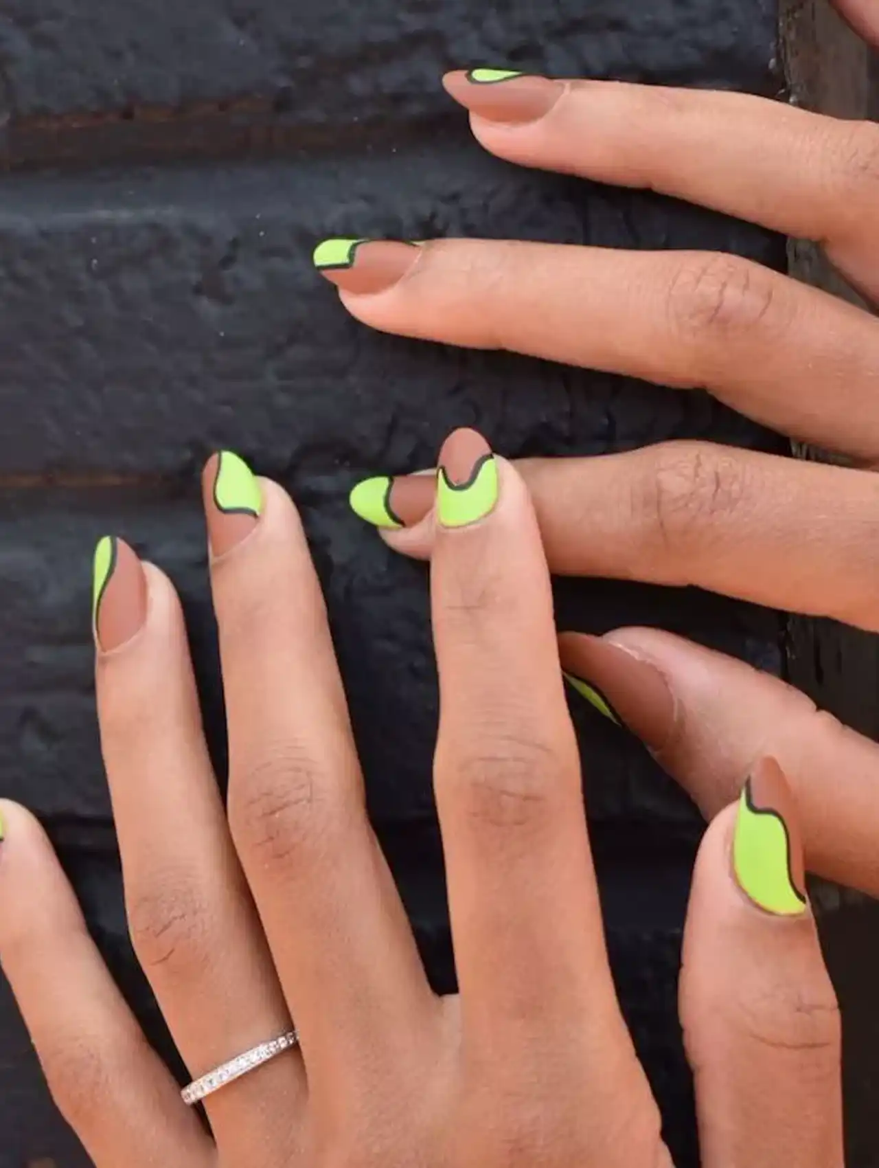 Neon nails with bright green tips on a cocoa brown base