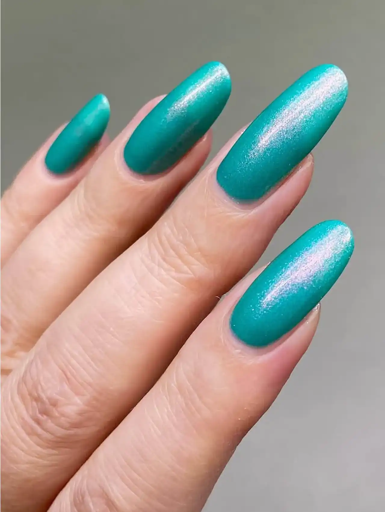 Neon turquoise nails with glossy shimmering highlights