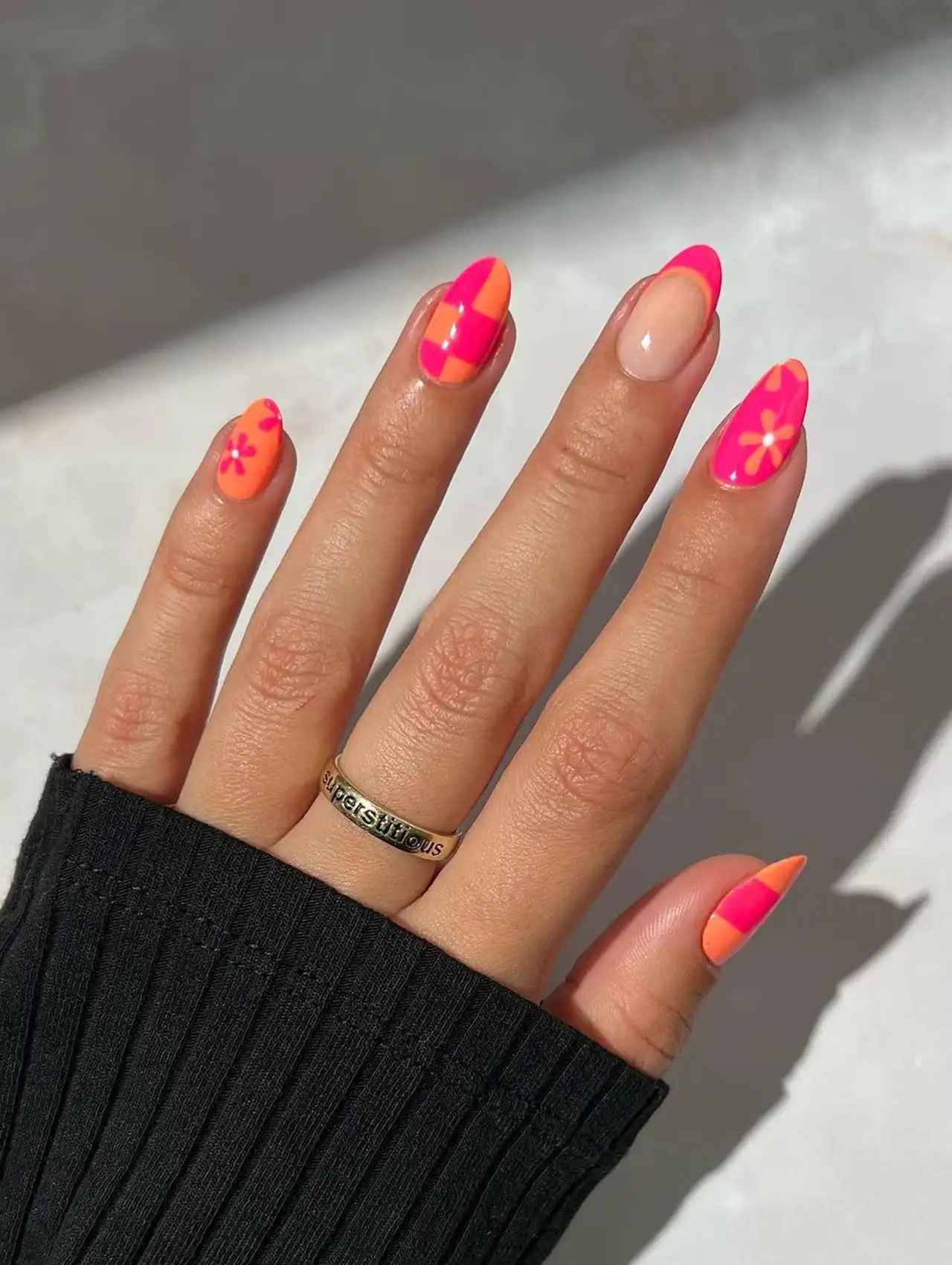 Bright pink and orange abstract nails with flowers and checkerboard for bold summer nail designs