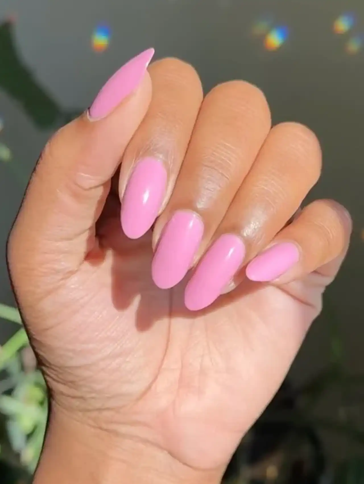 Glossy bubblegum pink almond-shaped nails for a simple summer nail design