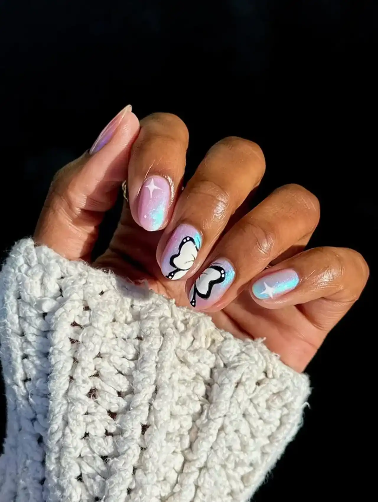 Pastel aurora nails with butterfly art and shimmer showcasing aurora nail design ideas