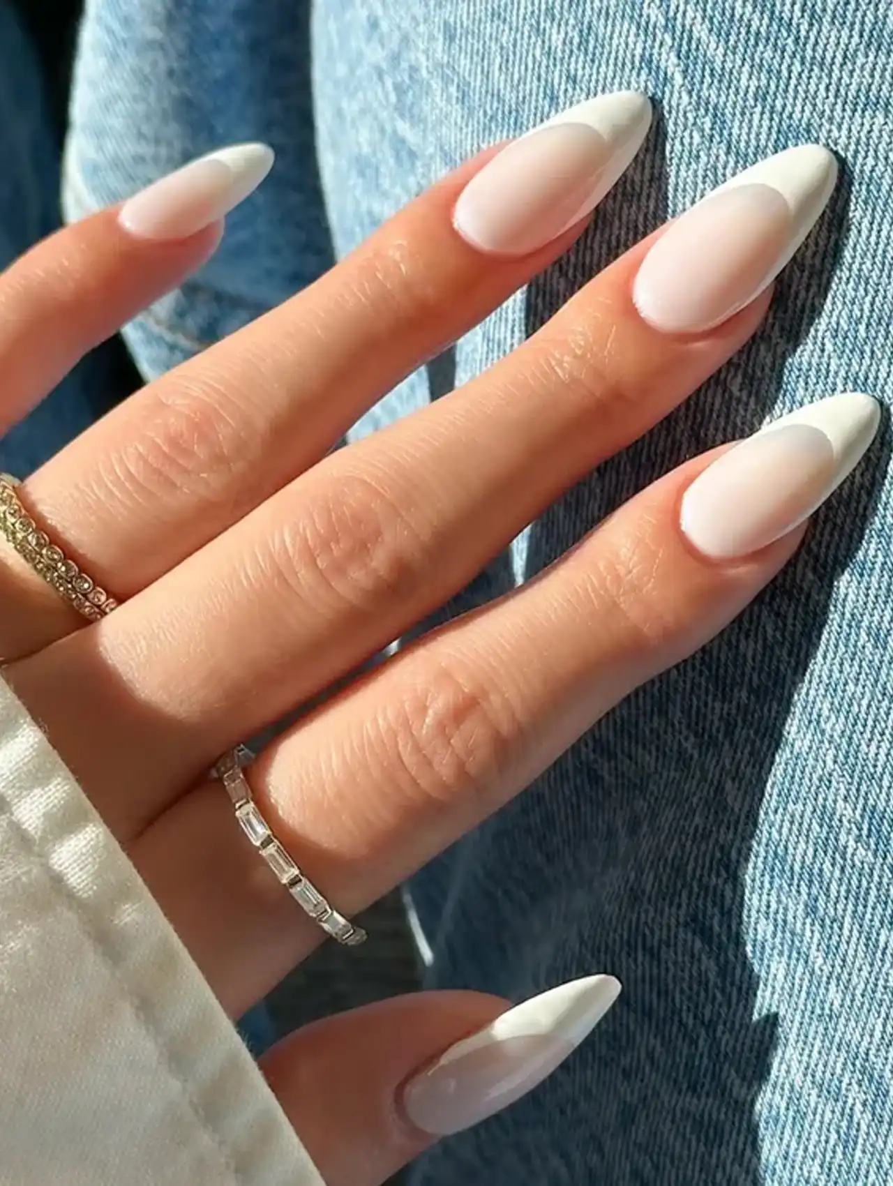 Creamy white almond-shaped French tips for a chic summer nail design