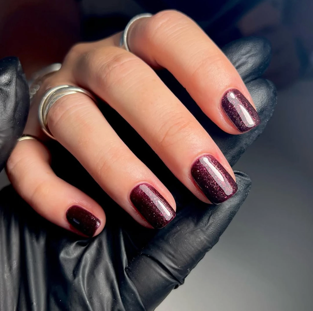 Diseño de uñas brillantes en tono burdeos con acabado glossy.