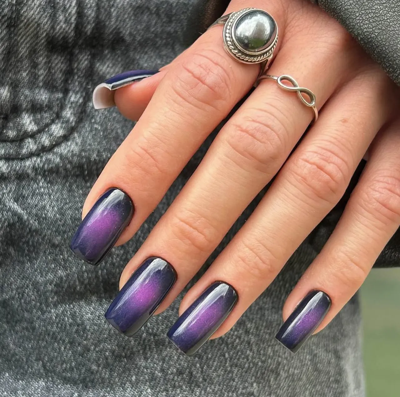 Efecto aura en uñas con tonos índigo y púrpura en acabado brillante.