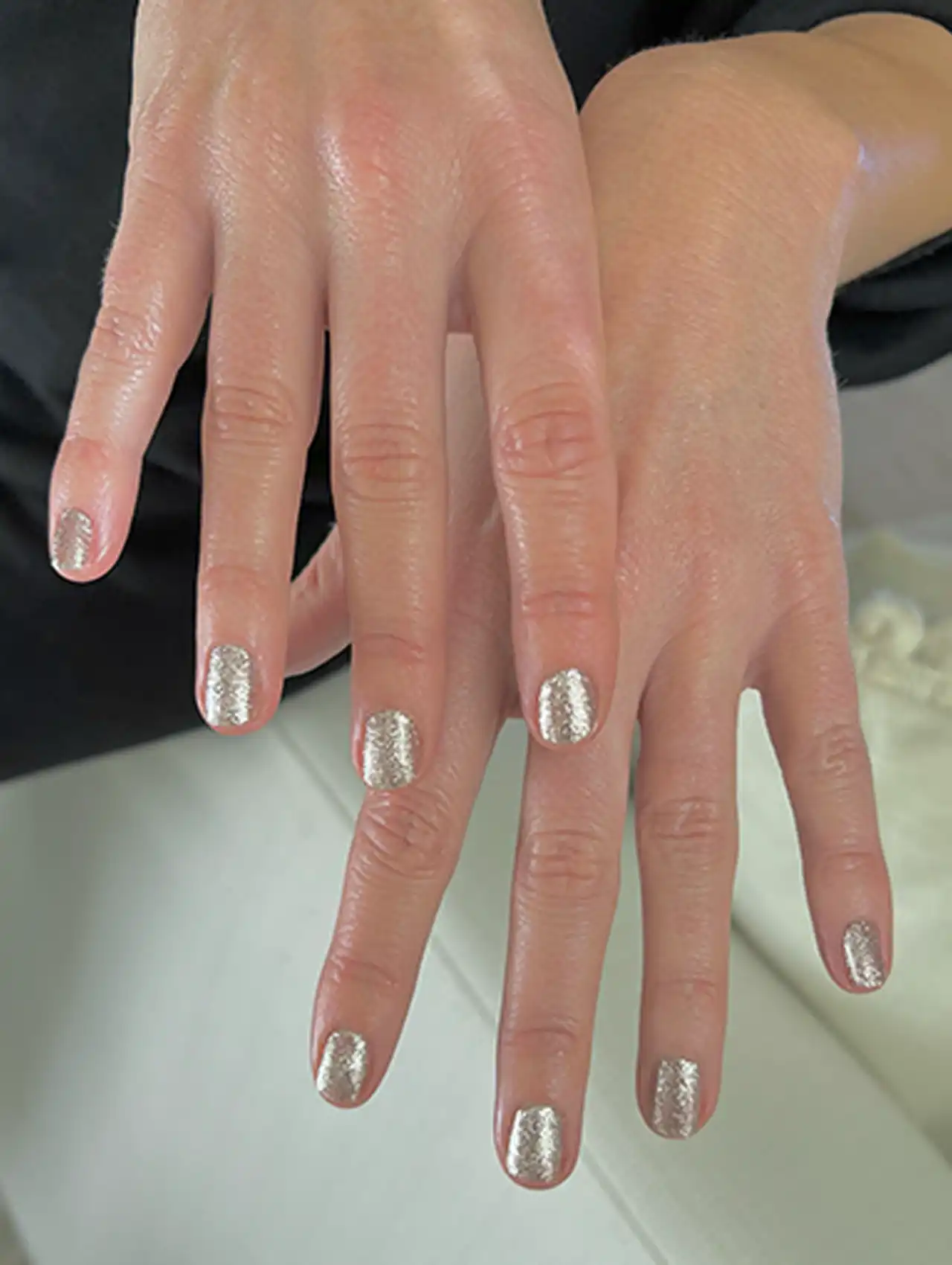 Emily Blunt with metallic silver celebrity nails in a shimmering finish