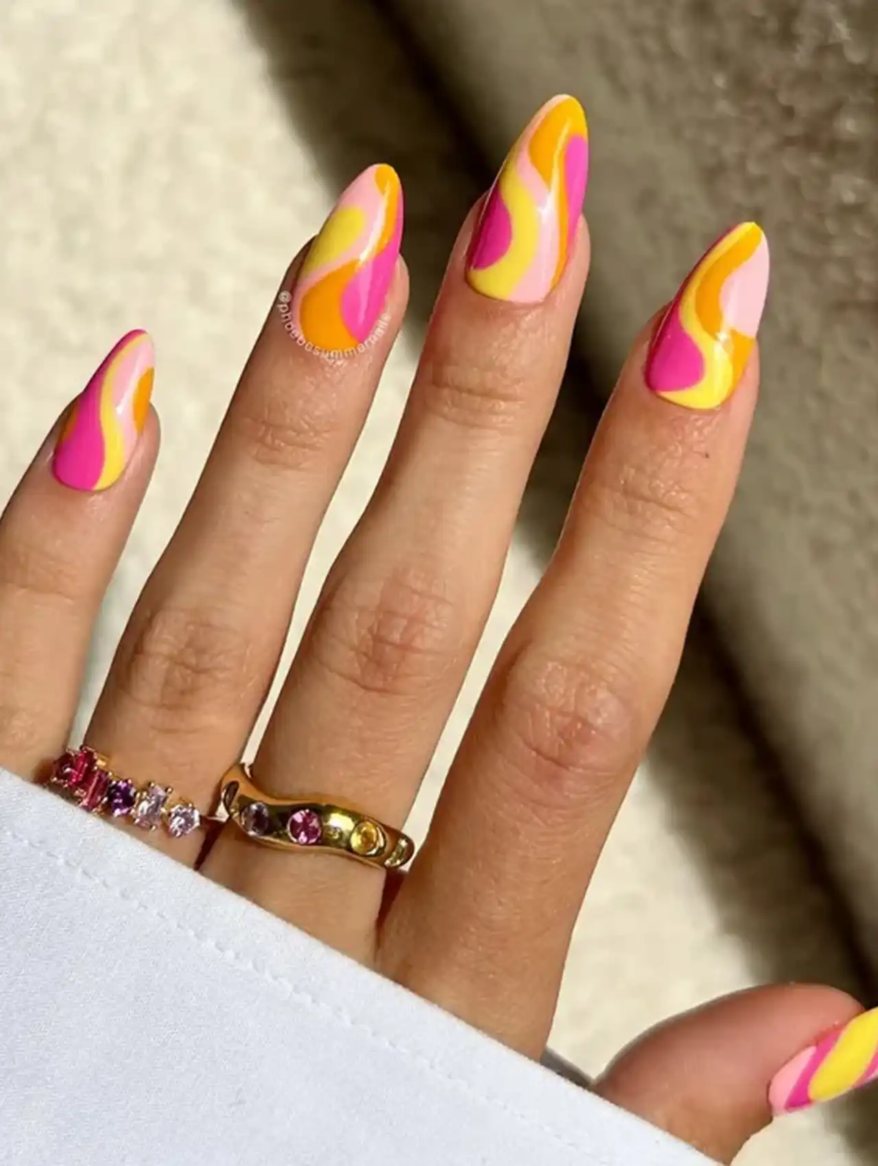 Neon swirl nails in pink, yellow, and orange for bold summer nail designs