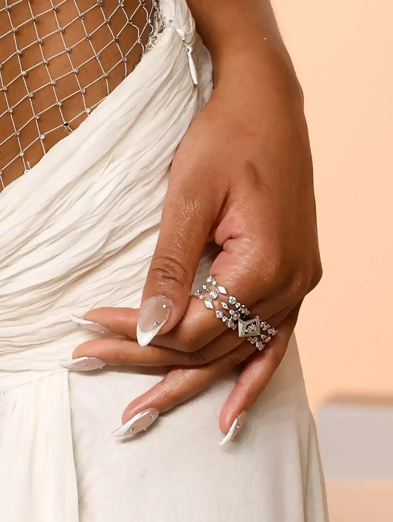 Keke Palmer showing sparkling French tip celebrity nails with diamond jewelry