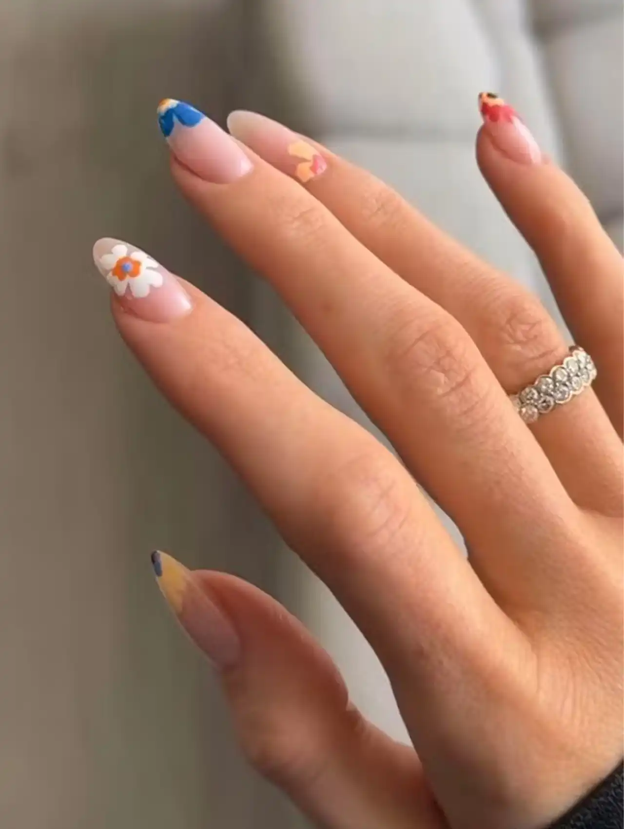 Kylie Jenner with whimsical floral celebrity nails featuring colorful daisy designs