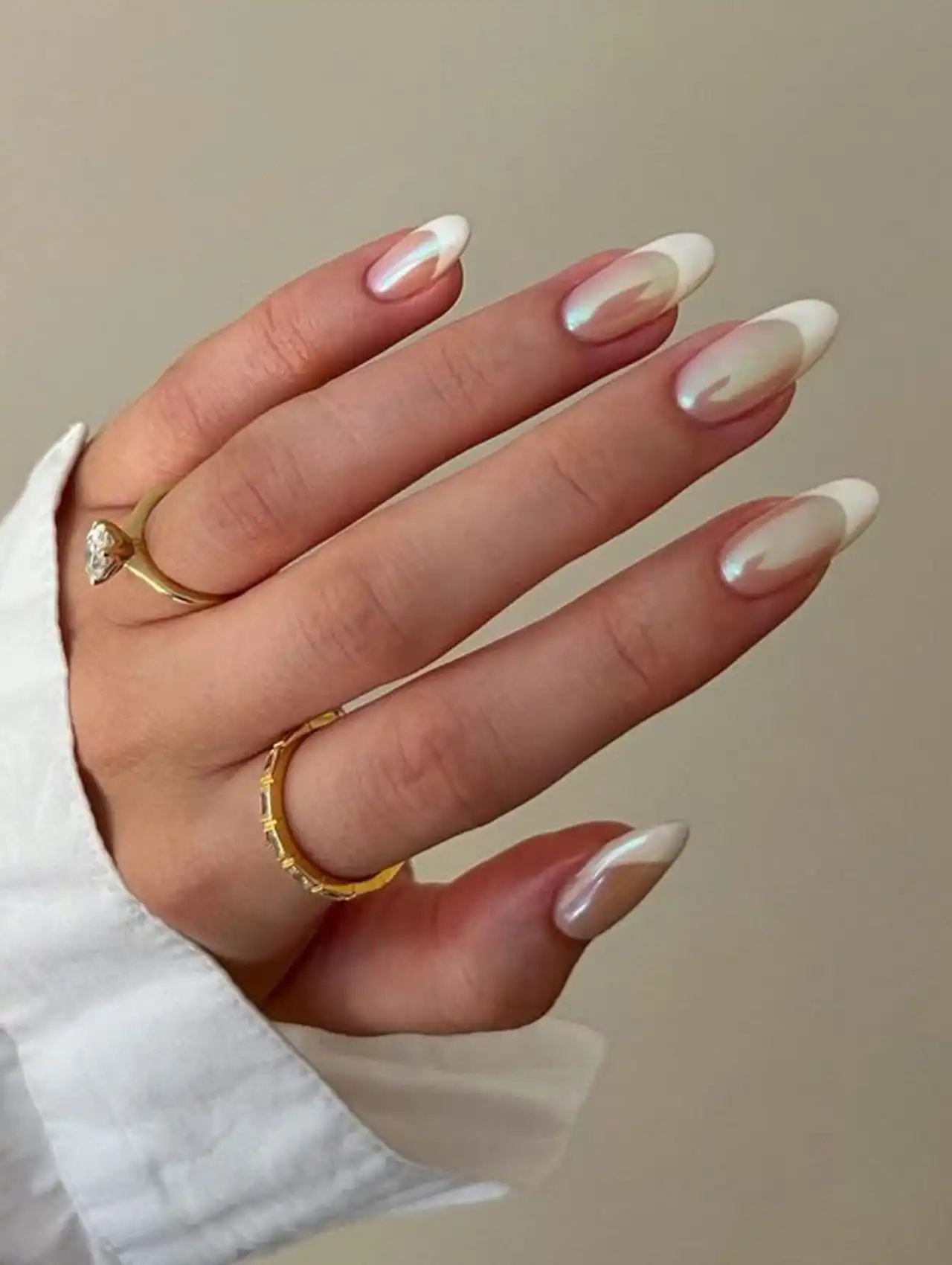 White pearl French tip nails with aurora shimmer showcasing aurora nail design ideas