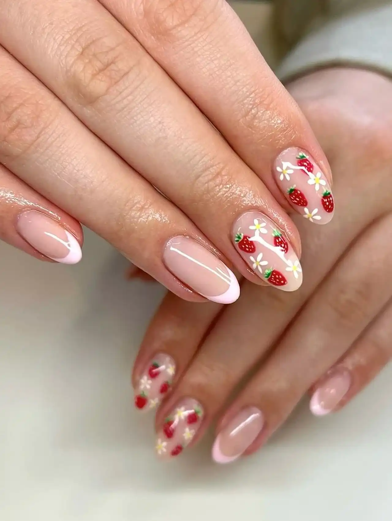 Strawberry and daisy nail art on a neutral base, perfect for cute summer nail designs