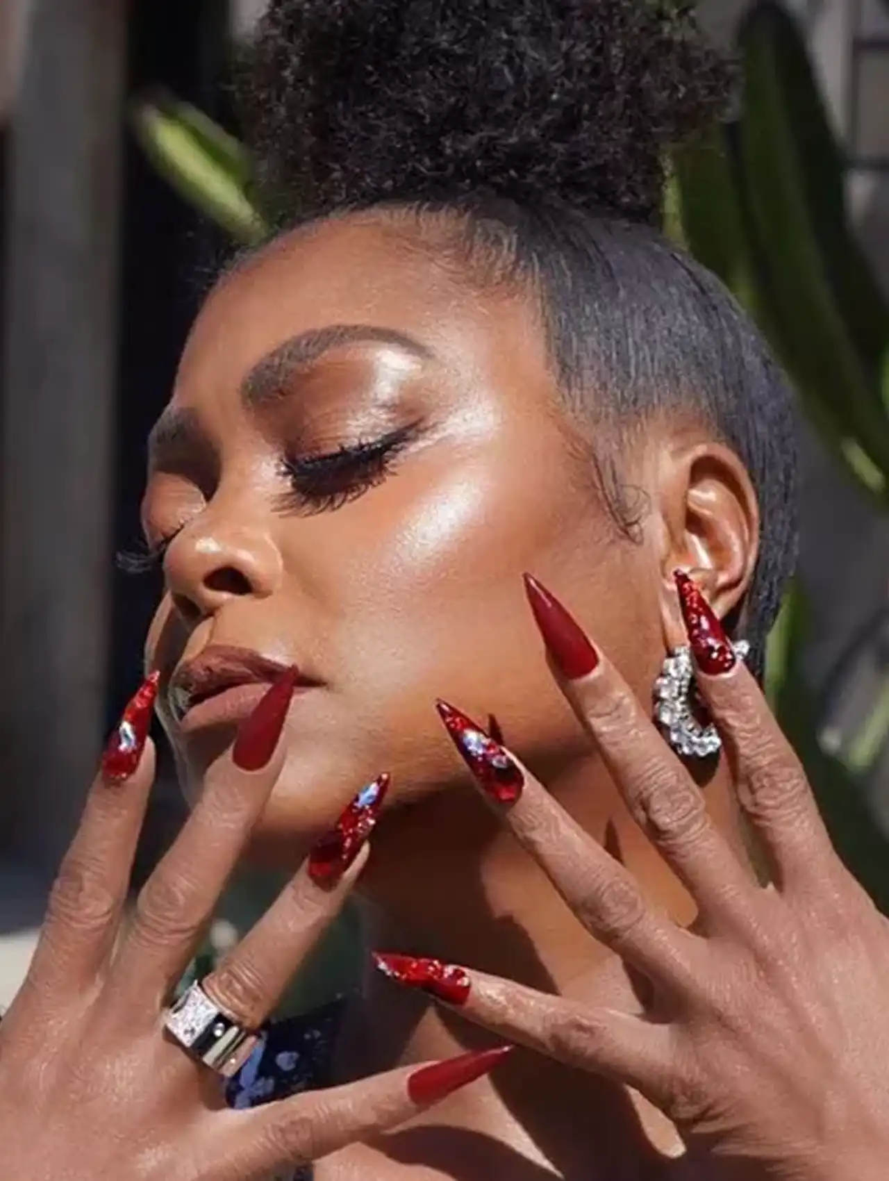 Taraji P. Henson flaunting long red stiletto celebrity nails with crystal embellishments