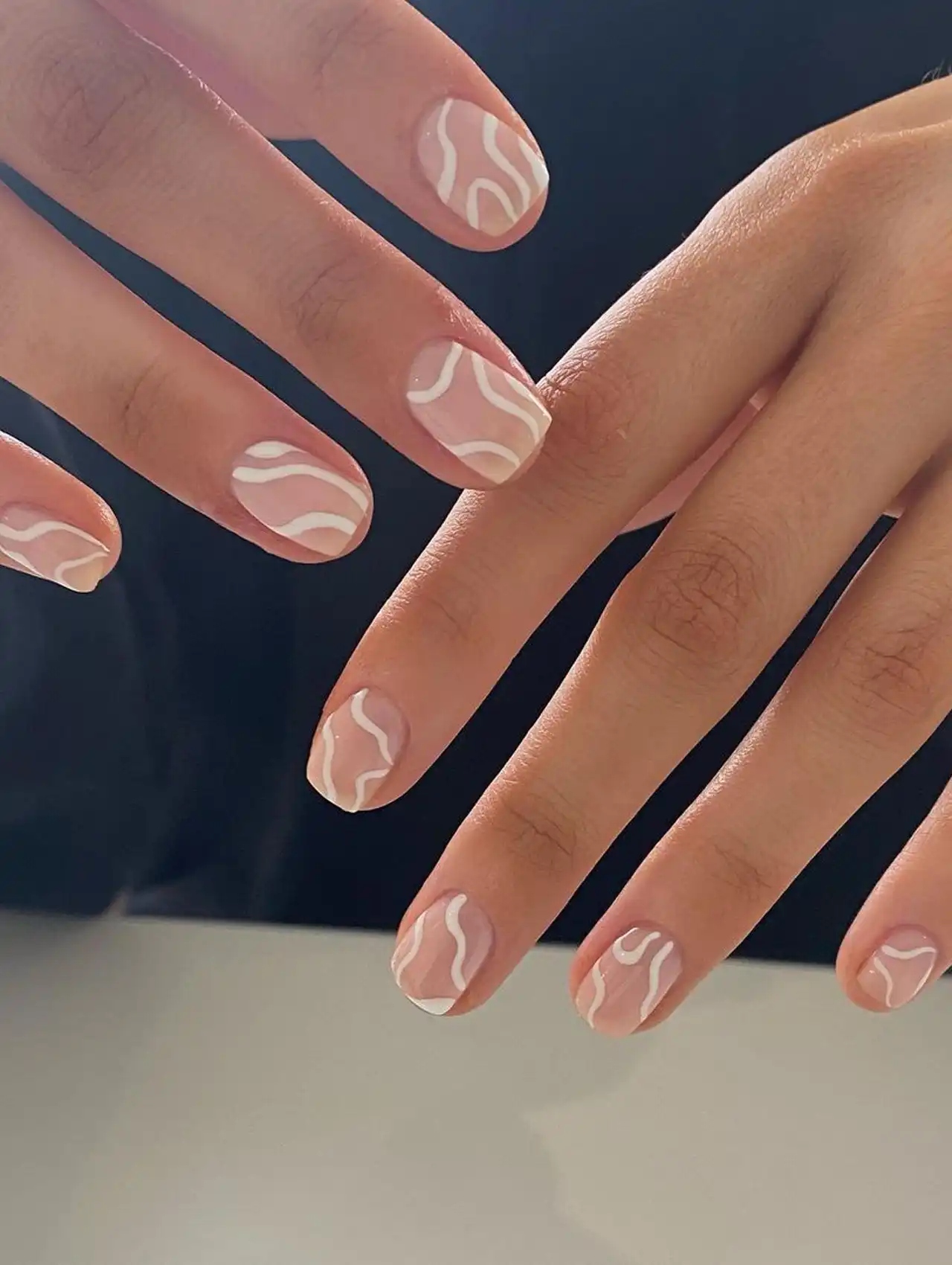 Minimalist nude nails with white wave designs – summer nail designs