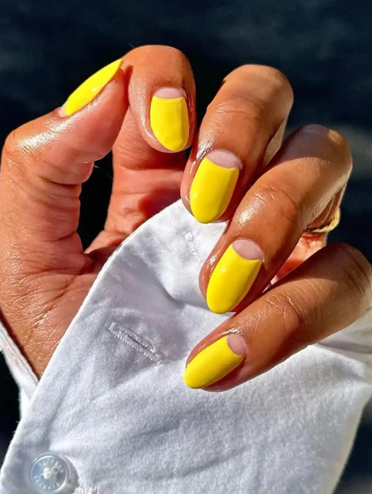 Yellow half-moon nails with a glossy finish for minimalist summer nail designs