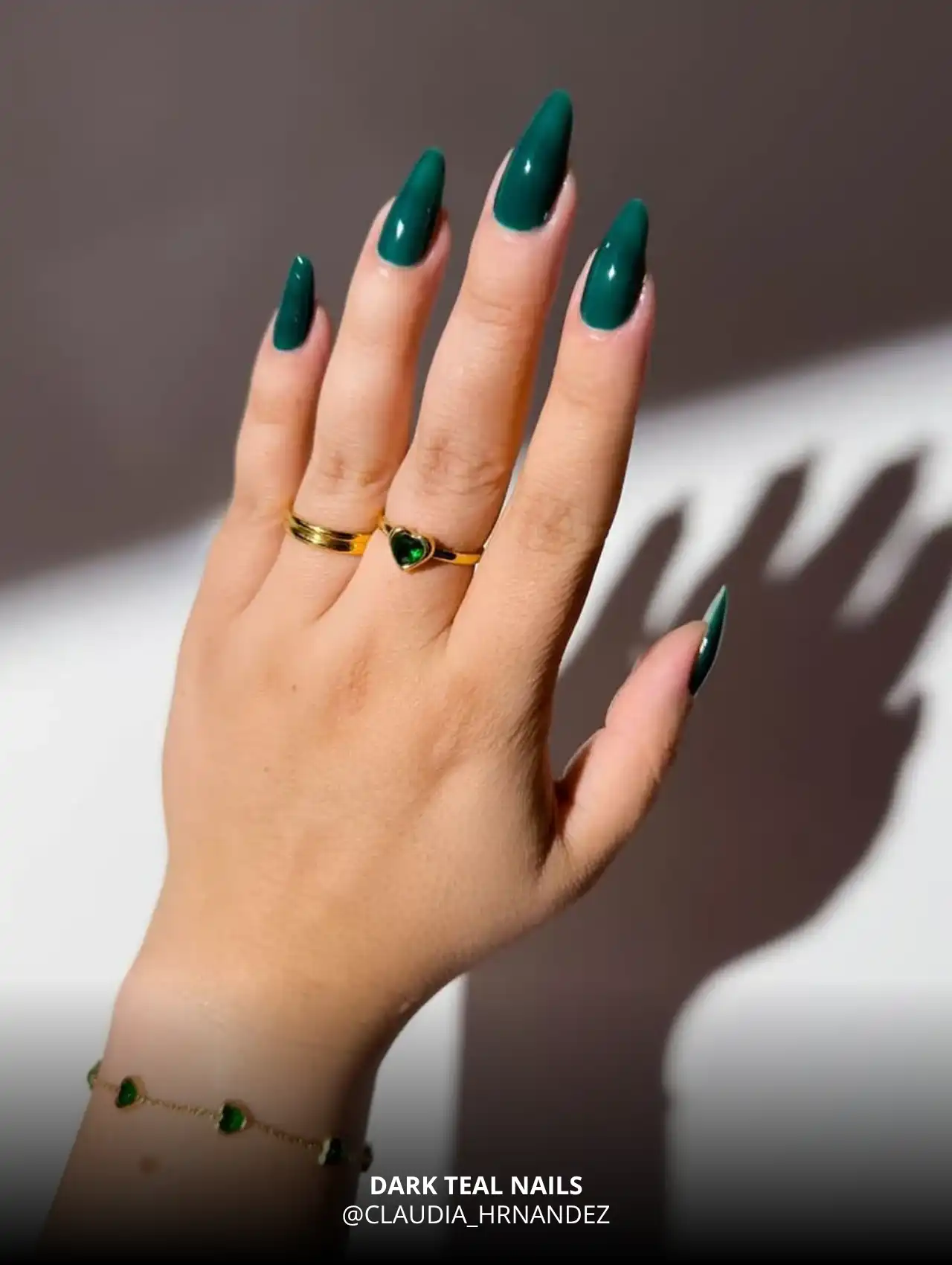Dark teal fall nail color with glossy finish.