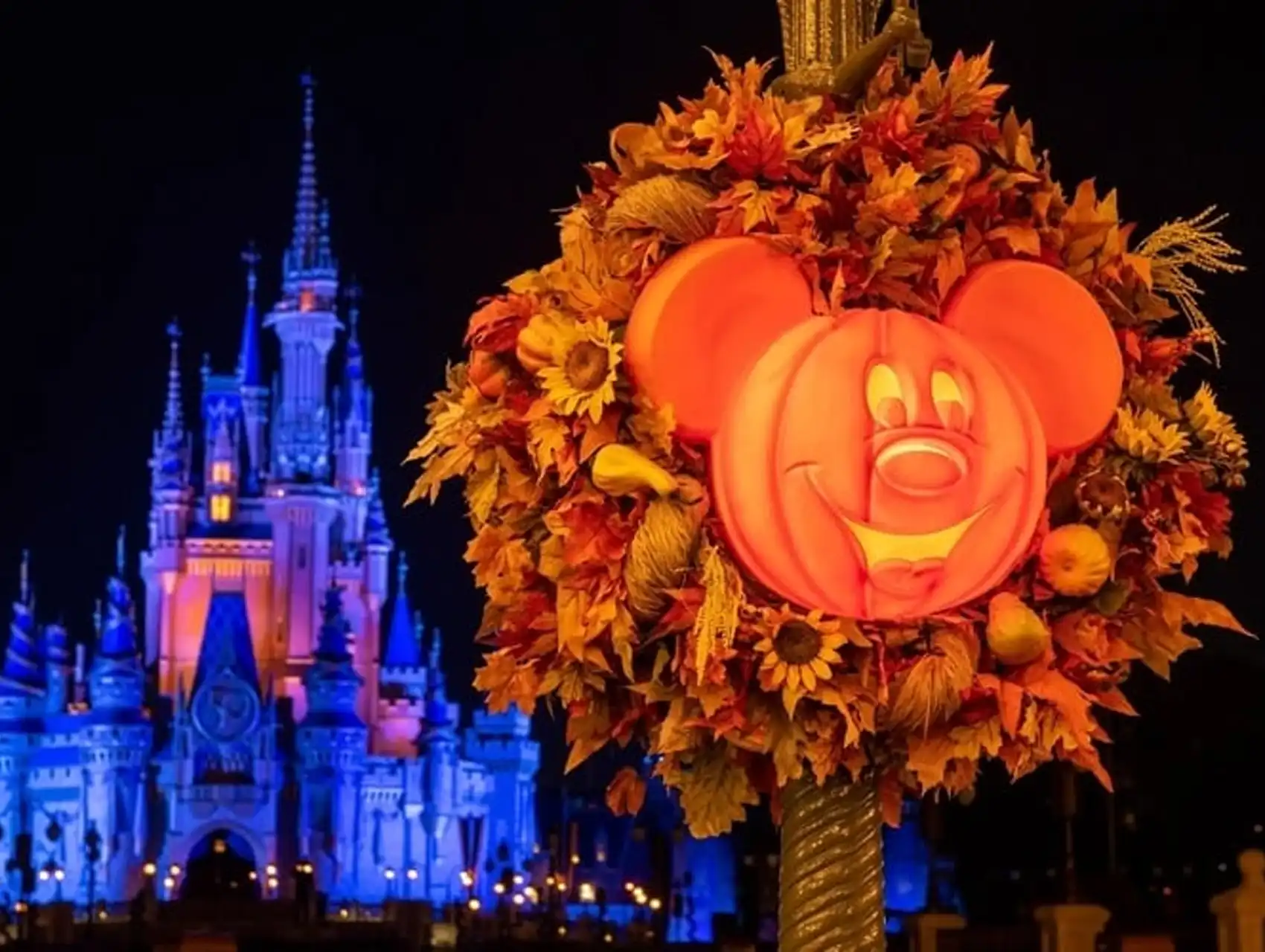 Mickey Mouse pumpkin Halloween decoration in front of Cinderella Castle at Walt Disney World during spooky season