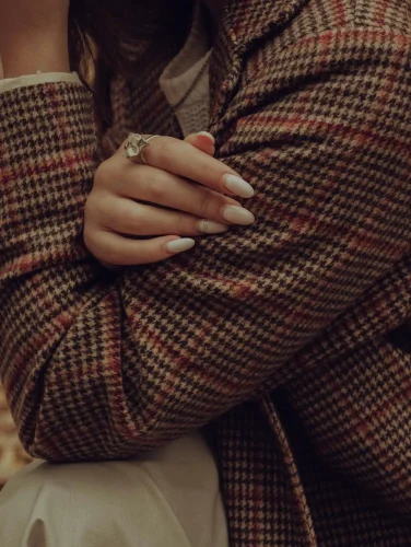 Elegant milky white almond fall nail paired with a plaid coat