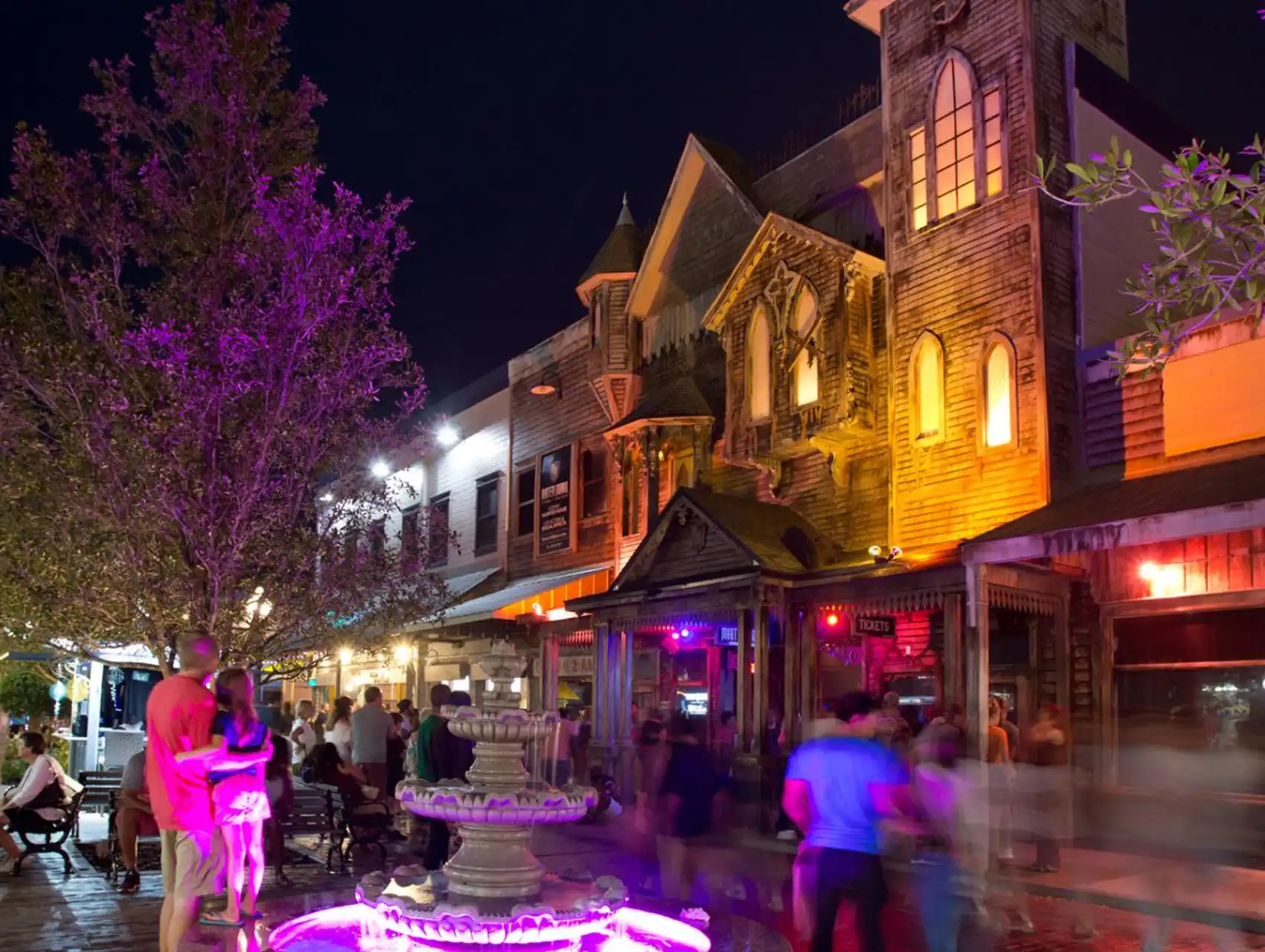 Exterior of Mortem Manor haunted attraction in Kissimmee lit up at night during Halloween.