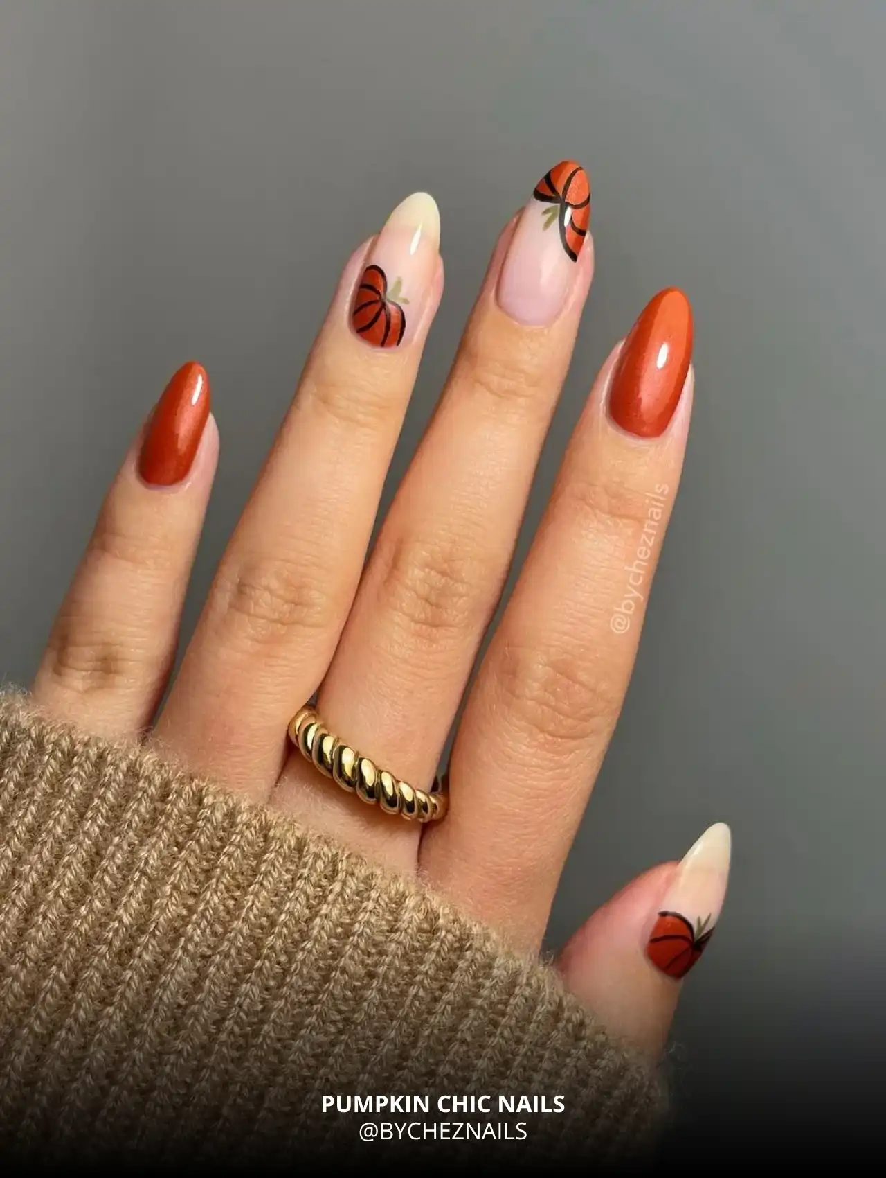 Pumpkin chic fall nail design with orange pumpkins and nude base.