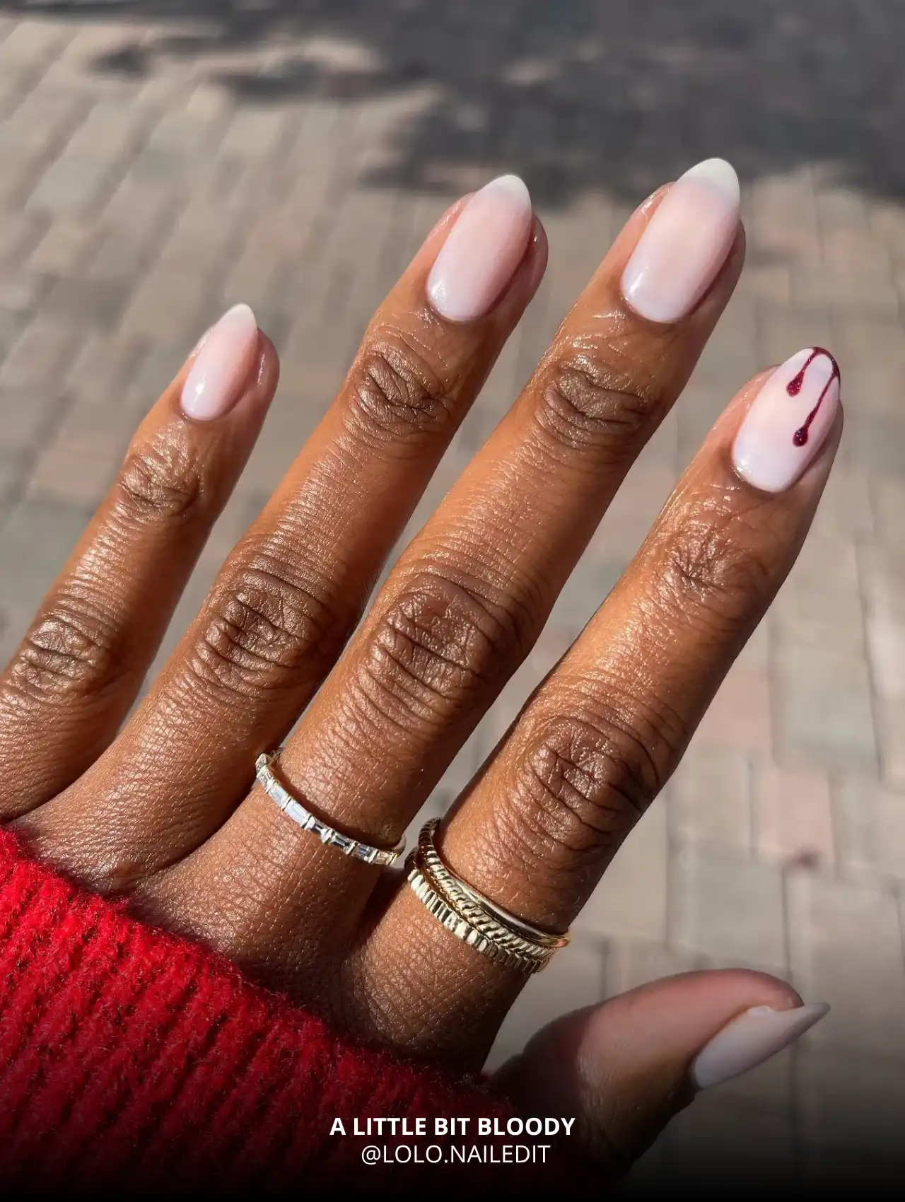 A Little Bit Bloody design featuring nude nails with subtle blood drip detail, trendy Halloween nails