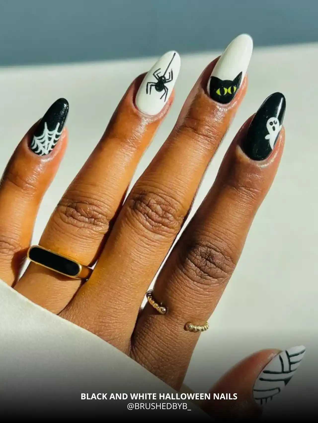 Black and white Halloween nails with spider, cat, and ghost designs, trendy Halloween nails